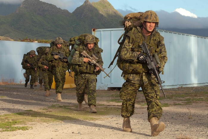 Canadian soldiers with Company G, 2nd Battalion, Royal Canadian Regiment, Canadian Army, move toward their next objective during a noncombatant evacuation operation at Marine Corps Training Area Bellows, Hawaii, July 26. The NEO, an emergency evacuation involving the use of military forces and capabilities in order to provide aid, assistance and movement to safety of American citizens overseas, was conducted as part of interoperability training between coalition forces during the multi-national Exercise Rim of the Pacific 2010.