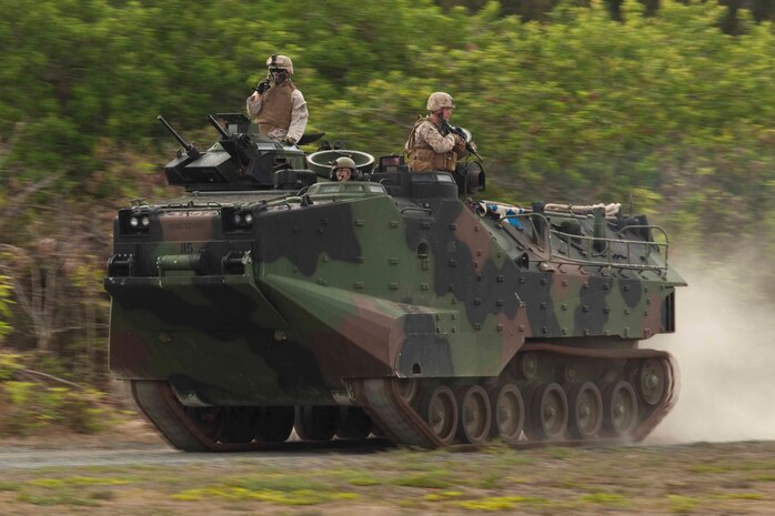 U.S. Marines assigned to 3rd Marine Regiment utilize amphibious assault vehicles to set up a cordon around a mock U.S. embassy during a noncombatant evacuation operation at Marine Corps Training Area Bellows, Hawaii, July 26. The NEO, an emergency evacuation involving the use of military forces and capabilities in order to provide aid, assistance and movement to safety of American citizens overseas, was conducted as part of interoperability training between coalition forces during the multi-national Exercise Rim of the Pacific 2010.