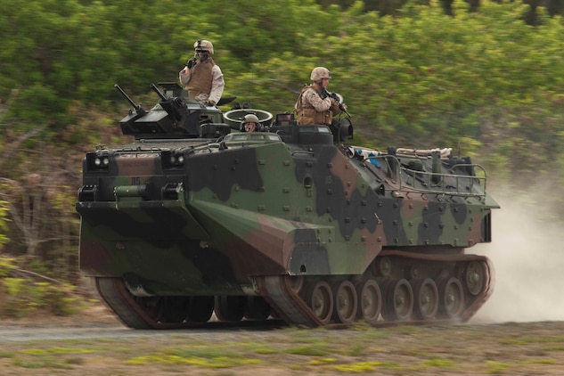 U.S. Marines assigned to 3rd Marine Regiment utilize amphibious assault vehicles to set up a cordon around a mock U.S. embassy during a noncombatant evacuation operation at Marine Corps Training Area Bellows, Hawaii, July 26. The NEO, an emergency evacuation involving the use of military forces and capabilities in order to provide aid, assistance and movement to safety of American citizens overseas, was conducted as part of interoperability training between coalition forces during the multi-national Exercise Rim of the Pacific 2010.