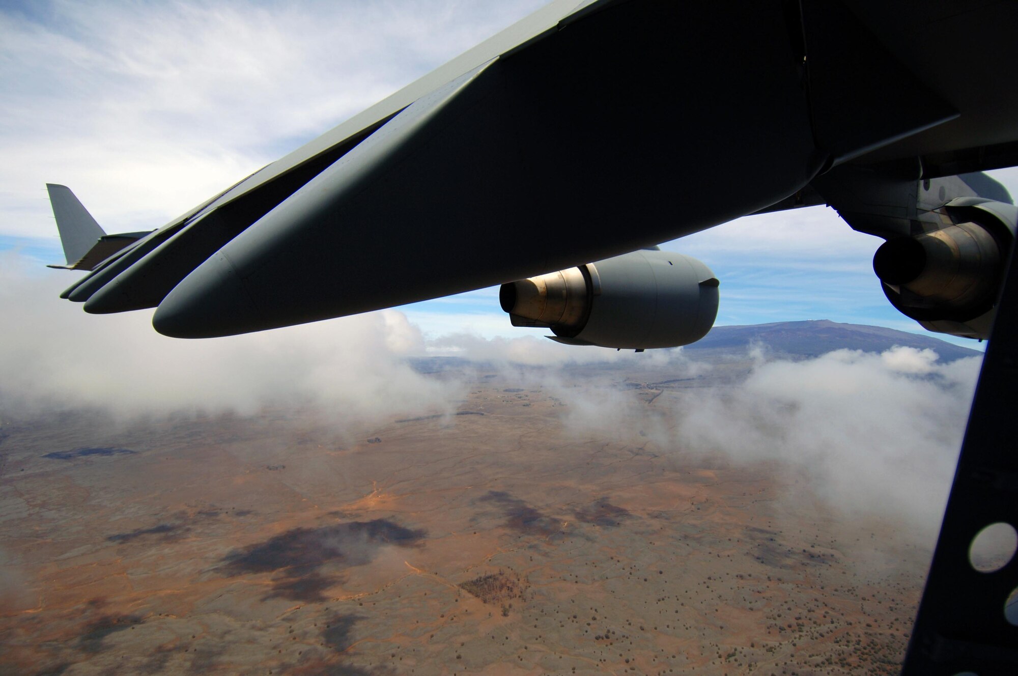 A C-17 flies over the island of Hawai'i in preparation for low-altitude flying maneuvers July 23. The sortie this aircraft flew included a simulated cargo drop, in-flight refueling, and participation in a simulated fire fight as part of a Rim of the Pacific exercise. (U.S. Air Force photo by Staff Sgt. Nathan Allen)