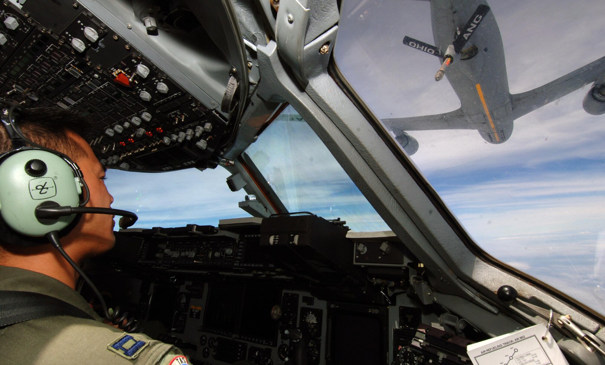 Capt. Jon Ma, 535th Airlift Squadron pilot, watches a KC-135 from the Ohio Air National Guard make its approach to refuel a C-17 July 23. The sortie the C-17 flew included a simulated cargo drop, in-flight refueling, and participation in a simulated fire fight as part of a Rim of the Pacific exercise. (U.S. Air Force photo by Staff Sgt. Nathan Allen)
