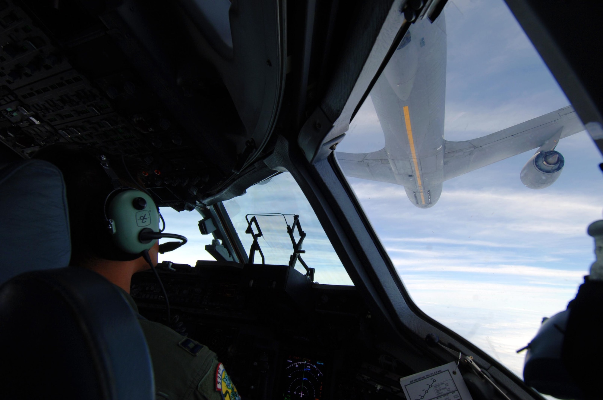 Capt. Jon Ma, 535th Airlift Squadron pilot, watches a KC-135 from the Ohio Air National Guard make its approach to refuel a C-17 July 23. The sortie the C-17 flew included a simulated cargo drop, in-flight refueling, and participation in a simulated fire fight as part of a Rim of the Pacific exercise. (U.S. Air Force photo by Staff Sgt. Nathan Allen)