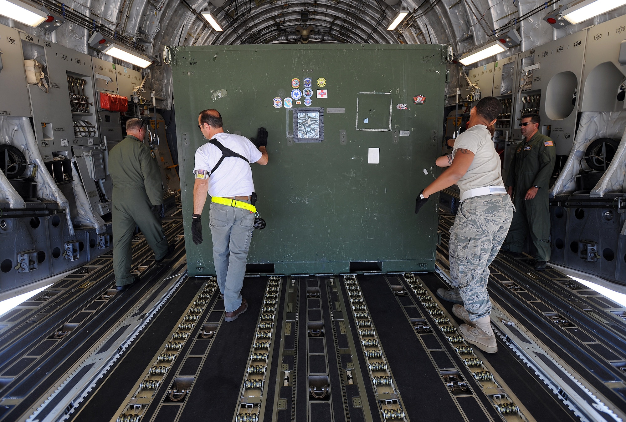 An aircrew from the 729th Airlift Squadron, out of March Air Reserve Base, Calif., and ground crew from Travis Air Force Base, Calif., load a litter stanchion augmentation set on board a C-17 Globemaster aircraft at Travis AFB in preparation for the weekly Integrated Continental United States Medical Operations Plan mission or ICMOP mission as it's known by it's acronym. The mission picks up war wounded and other patients at Andrews Air Force Base, Md., and returns them to their homes throughout the United States.   (U.S. Air Force photo by Master Sgt. Rick Sforza)