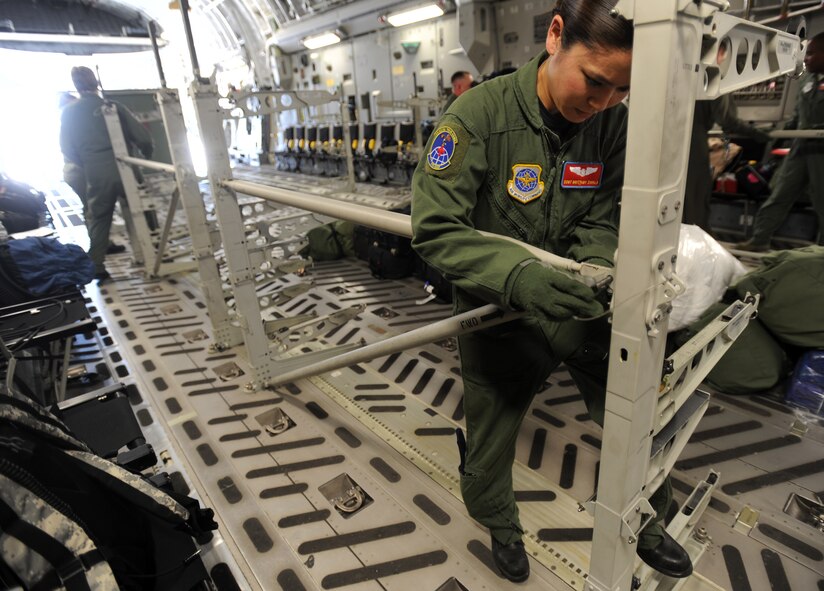 Staff Sgt Brittany Zavala, an aeromedical evacuation technician from the 775th Expeditionary Aeromedical Evacuation Flight Travis Air Force Base, Calif., assembles a litter stanchion on board a C-17 Globemaster aircraft at Travis AFB, in preparation for the weekly Integrated Continental United States Medical Operations Plan mission or ICMOP mission as it's known by it's acronym. The mission picks up war wounded and other patients at Andrews Air Force Base, Md., and returns them to their homes throughout the United States.   (U.S. Air Force photo by Master Sgt. Rick Sforza)