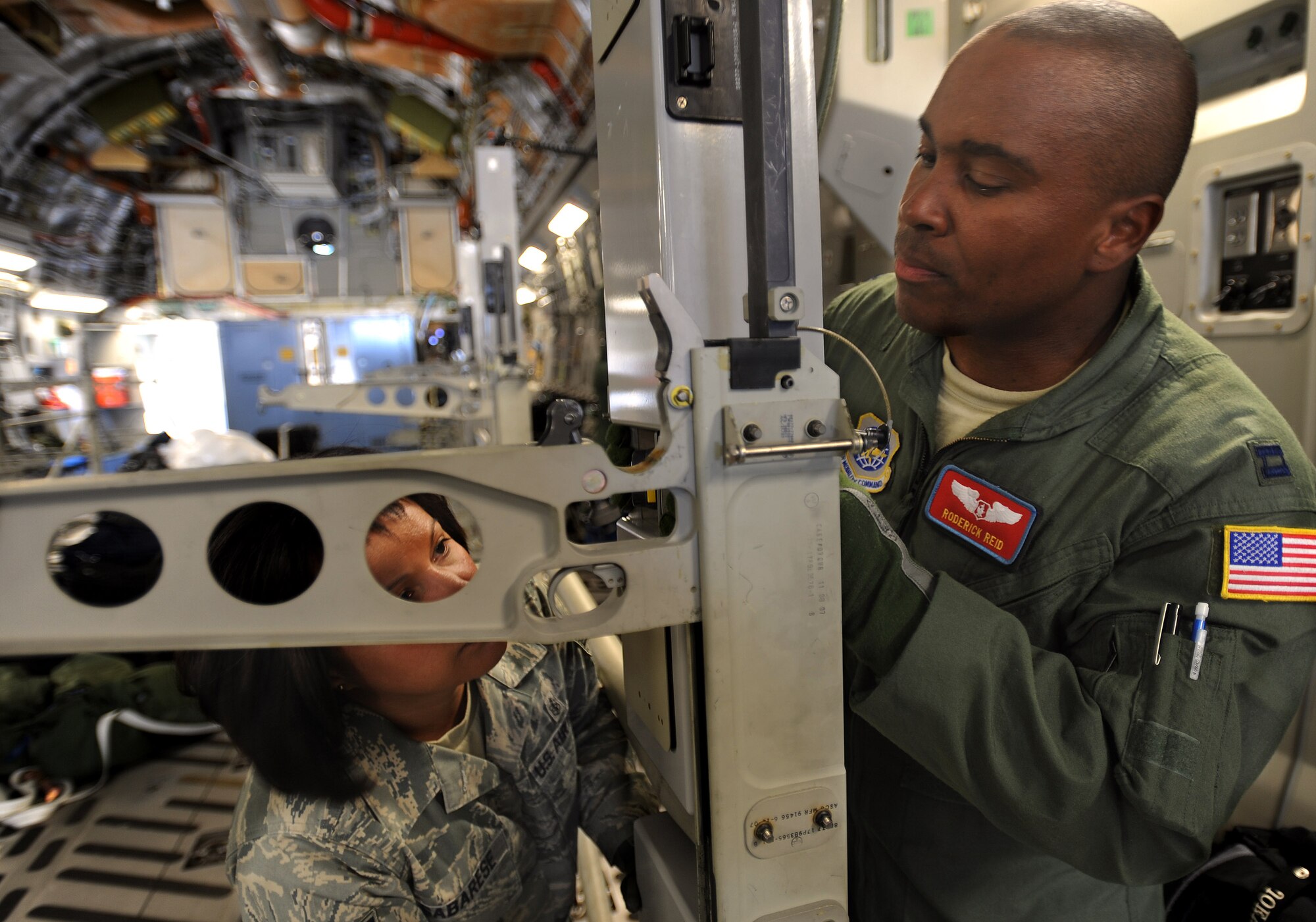 Technical Sgt Maria Sabarese, left,a health services management technician, and Captain Roderick Reid, a flight nurse, both from the 775th Expeditionary Aeromedical Evacuation Flight Travis Air Force Base, Calif., assemble a litter stanchion on board a C-17 Globemaster aircraft at Travis AFB, in preparation for the weekly Integrated Continental United States Medical Operations Plan mission or ICMOP mission as it's known by it's acronym. The mission picks up war wounded and other patients at Andrews Air Force Base, Md., and returns them to their homes throughout the United States.   (U.S. Air Force photo by Master Sgt. Rick Sforza)