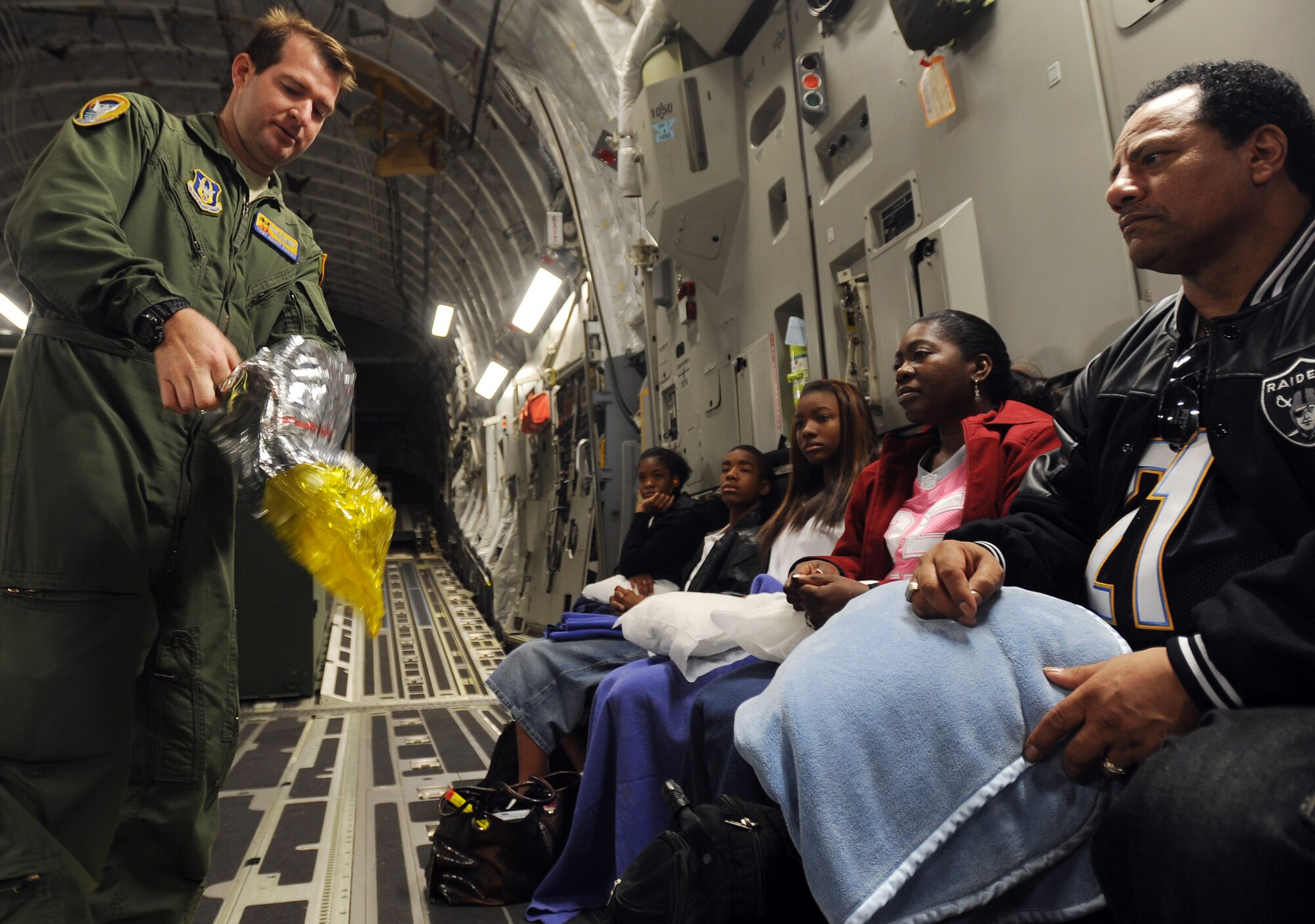 Tech Sgt Geoff Parrish, a loadmaster from the 729th Airlift Squadron, give passengers a pre-flight brief on a C-17 Globemaster III aircraft at Naval Air Station North Island, Calif., during the weekly Integrated Continental United States Medical Operations Plan mission or ICMOP mission as it's known by it's acronym. The mission picks up war wounded and other patients at Andrews Air Force Base, Calif., and returns them to their homes throughout the United States.   (U.S. Air Force photo by Master Sgt. Rick Sforza)