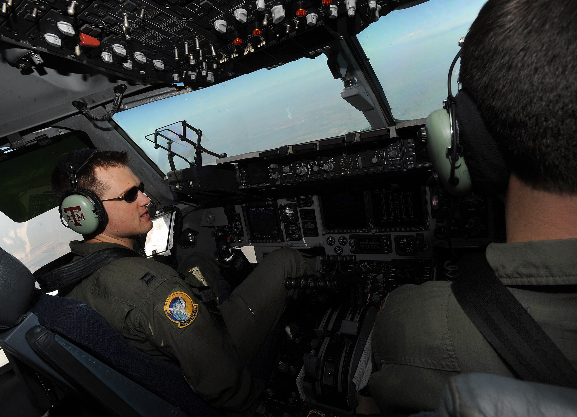 Capt. Jonathan Askins, left, and Maj. Jason Ausdemore, both pilots from the 729th Airlift Squadron, prepare to land a C-17 Globemaster III aircraft at Peterson Air Force Base, Colo., to drop off patients during the weekly ICMOP mission. (U.S. Air Force photo by Master Sgt. Rick Sforza)