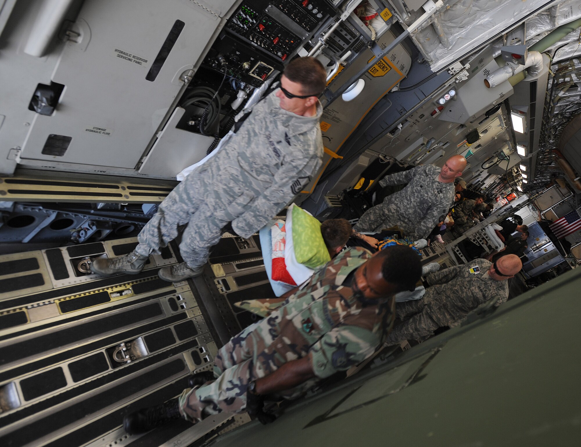 A medical team carries a wounded soldier off a 729th Airlift Squadron C-17 Globemaster III aircraft at Scott Air Force Base, Ill., during the weekly Integrated Continental United States Medical Operations Plan mission. The mission picks up war wounded and other patients at Andrews Air Force Base, Md., and returns them to their homes throughout the United States. (U.S. Air Force photo by Master Sgt. Rick Sforza)