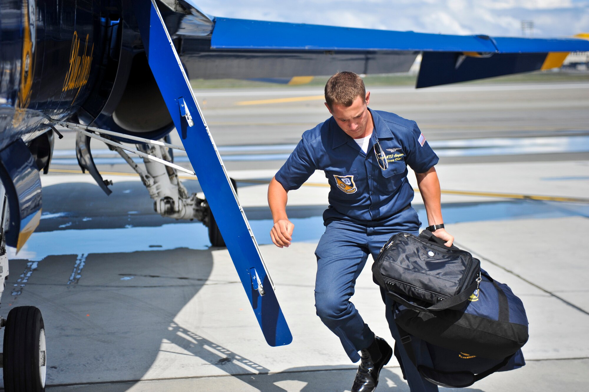 JOINT BASE ELMENDORF-RICHARDSON, Alaska – A Blue Angels’ crew chief takes luggage from one of the Blue Angels aircraft after landing at Joint Base Elmendorf-Richardson July 27. The Blue Angels will be one of the main performances during this year’s Arctic Thunder Air Show, taking place July 31 and Aug. 1. Gates open at 9 a.m. and parking and admission are free. (Air Force photo by Airman 1st Class Christopher Gross)