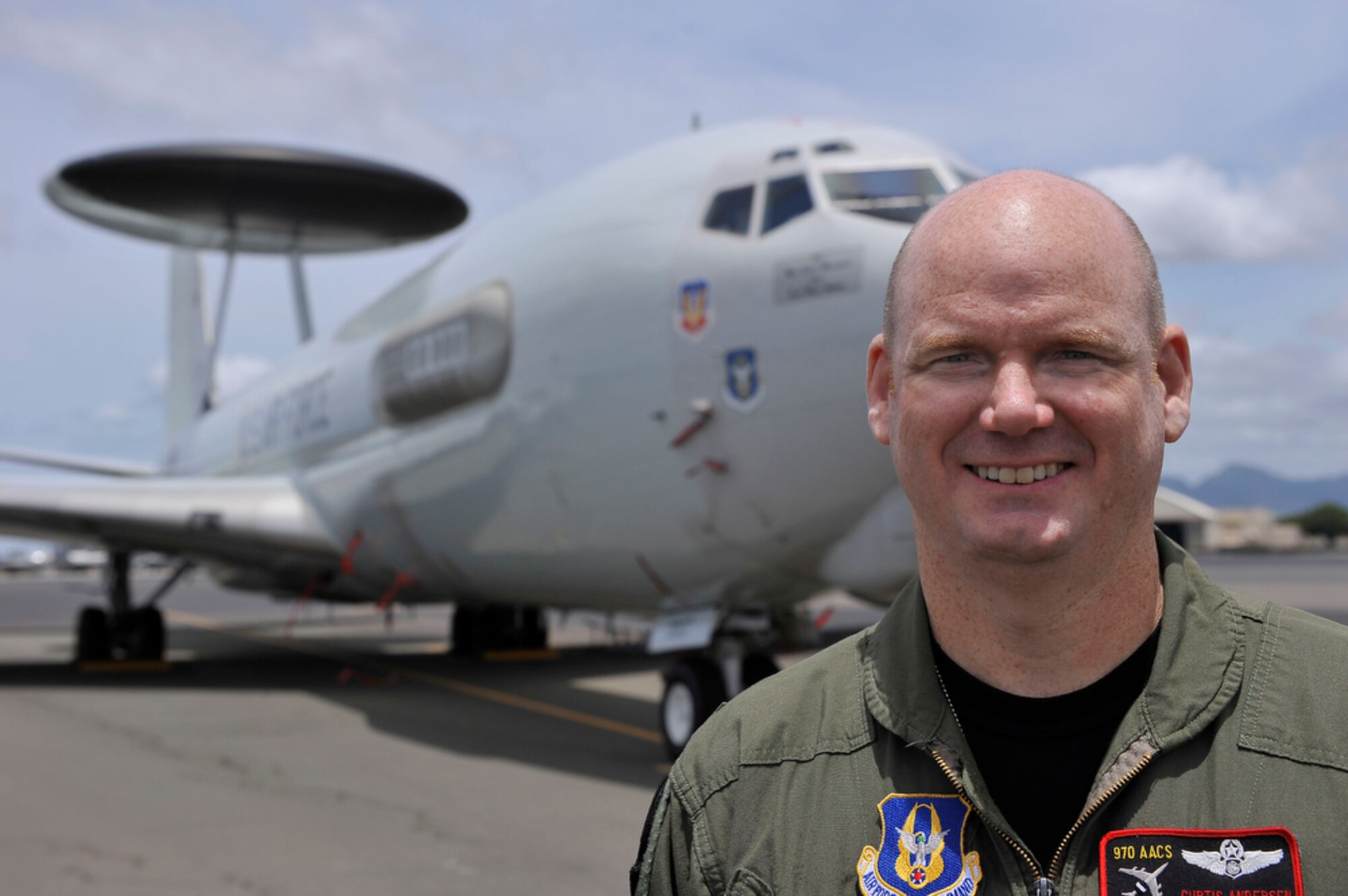 Lt. Col. Curtis Andersen, from the 970th Airborne Air Control Squadron at Tinker Air Force Base, Okla., poses in front of his E-3B Sentry before a mission scenario while at Joint Base Pearl Harbor-Hickam, Hawaii, in support of the Rim of the Pacific exercise. RIMPAC is the largest maritime exercise in the world and is held biennially. It stresses interoperability of all partner nations as a key element of regional stability.  (U.S.  Air Force photo/Tech Sgt. Cohen A. Young)