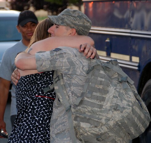 Senior Airman Andrew Van Arb, 9th Security Forces Squadron, hugs a family member July 26 upon returning home from Bagram Airfield, Afghanistan. Many leaders have described the recent deployment actions of the 9th SFS Airmen as heroic and noble. (Photo by Airman 1st Class Chuck Broadway)