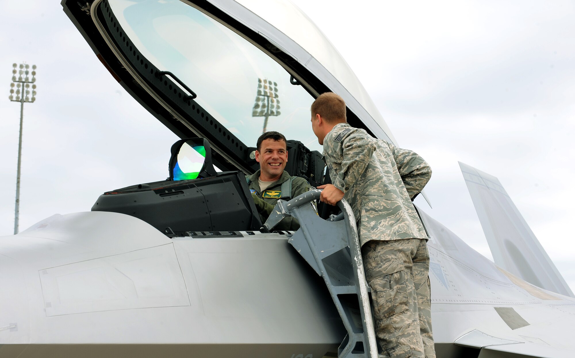LANGLEY AIR FORCE BASE, Va. – LANGLEY AIR FORCE BASE, Va. – Col. Matt Molloy, 1st Fighter Wing commander, speaks with Staff Sgt. Daniel Glabinski, 94th Air Maintenance Unit crew chief, after landing the newest 1st FW F-22 Raptor Flag Ship July 27.  The fifth generation fighter has been updated to carry a larger payload, has a more advanced radar system and has been modified so it will be easier to maintain. (U.S. Air Force photo/Staff Sgt. Tabitha Kuykendall) 