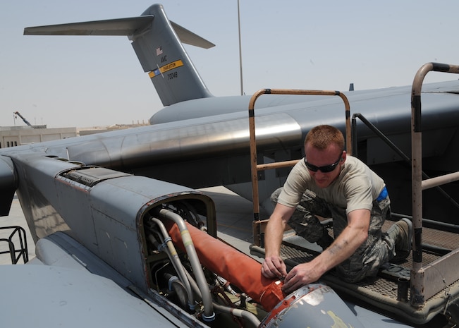 Tech. Sgt. Allen Minner works to remove a protective covering during preventive maintenance on a Charleston C-17 at an undisclosed location in Southwest Asia July 11, 2010. Sergeant Minner is currently deployed with the 8th Expeditionary Aircraft Maintenance Squadron. He is an electrical and environmental craftsman with the 437th Aircraft Maintenance Squadron. (U.S. Air Force photo/Senior Airman Katie Gieratz)