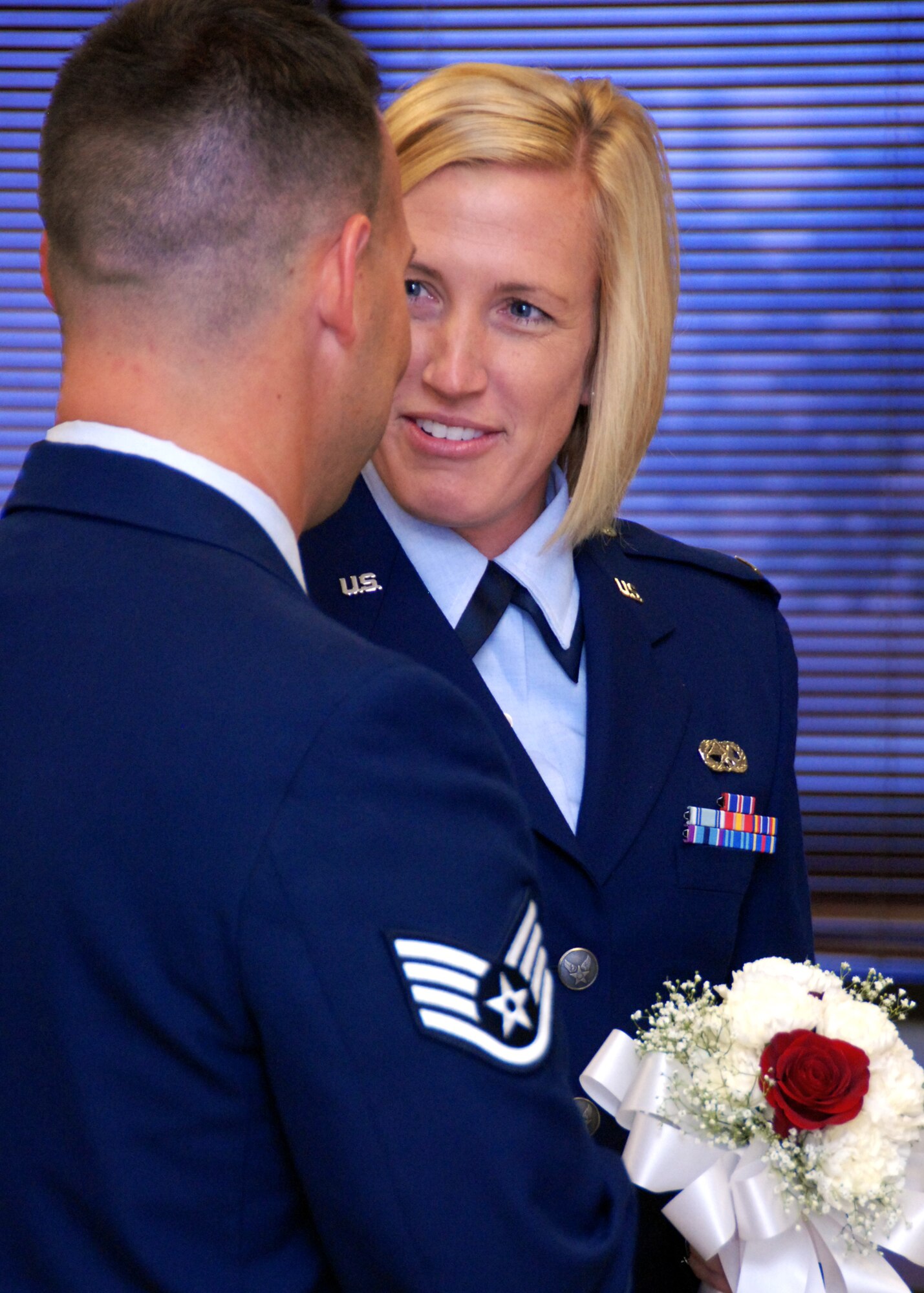 2nd Lt. Angela Anderson, 96th Inpatient Squadron, reacts to her husband Staff Sgt. Jake Anderson, 1st Special Operations Component Maintenance Squadron, during renewal of their vows at a surprise ceremony July 26 at Eglin Air Force Base, Fla.  Sergeant Anderson surprised his wife by putting together an official military-style wedding for their first anniversary.  (U.S. Air Force photo/Samuel King Jr.)