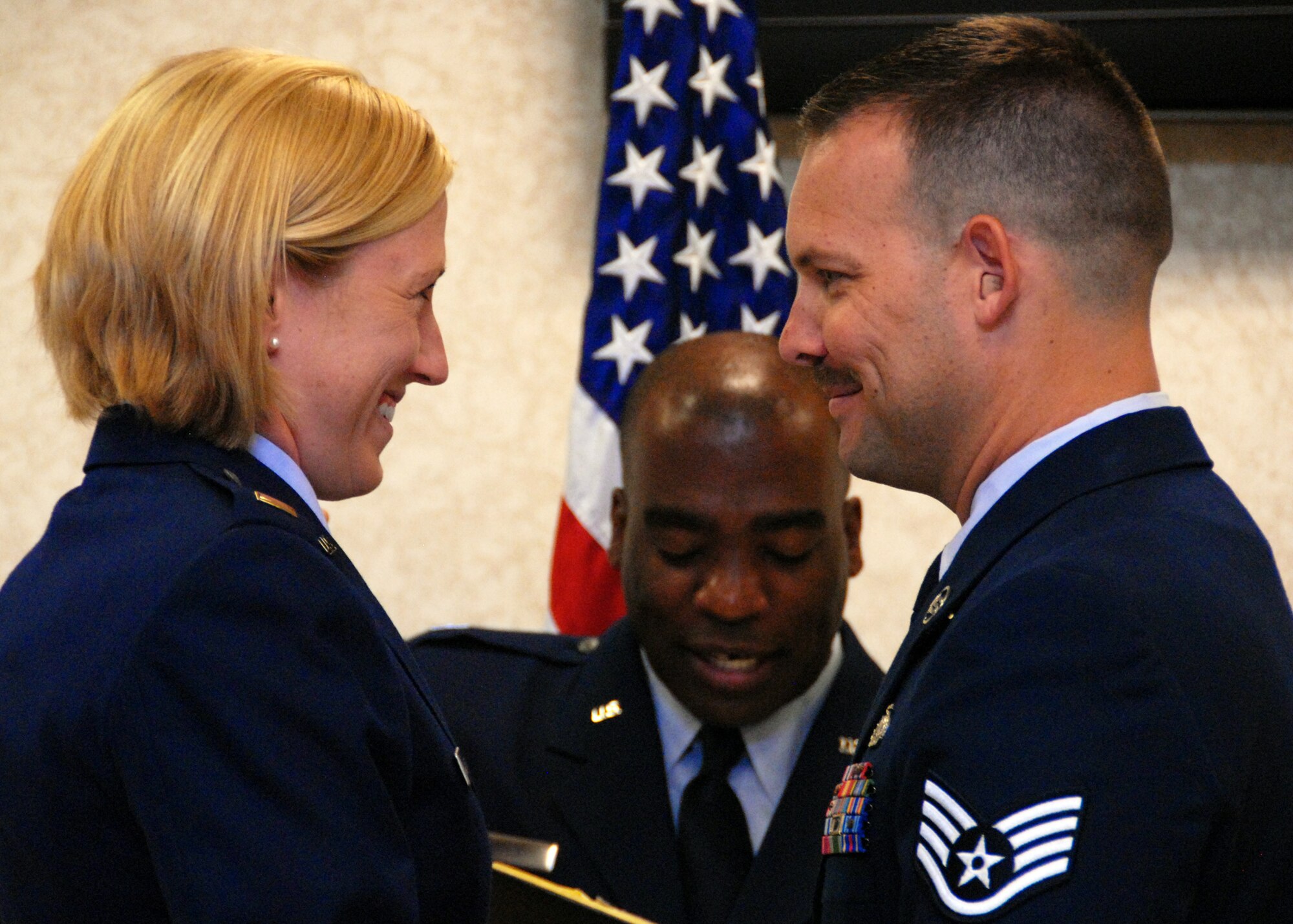 2nd Lt. Angela Anderson, 96th Inpatient Squadron, and husband Staff Sgt. Jake Anderson, 1st Special Operations Component Maintenance Squadron, gaze at each other during renewal of their vows at a surprise ceremony July 26 at Eglin Air Force Base, Fla.  Sergeant Anderson surprised his wife by putting together an official military-style wedding for their first anniversary.  (U.S. Air Force photo/Samuel King Jr.)