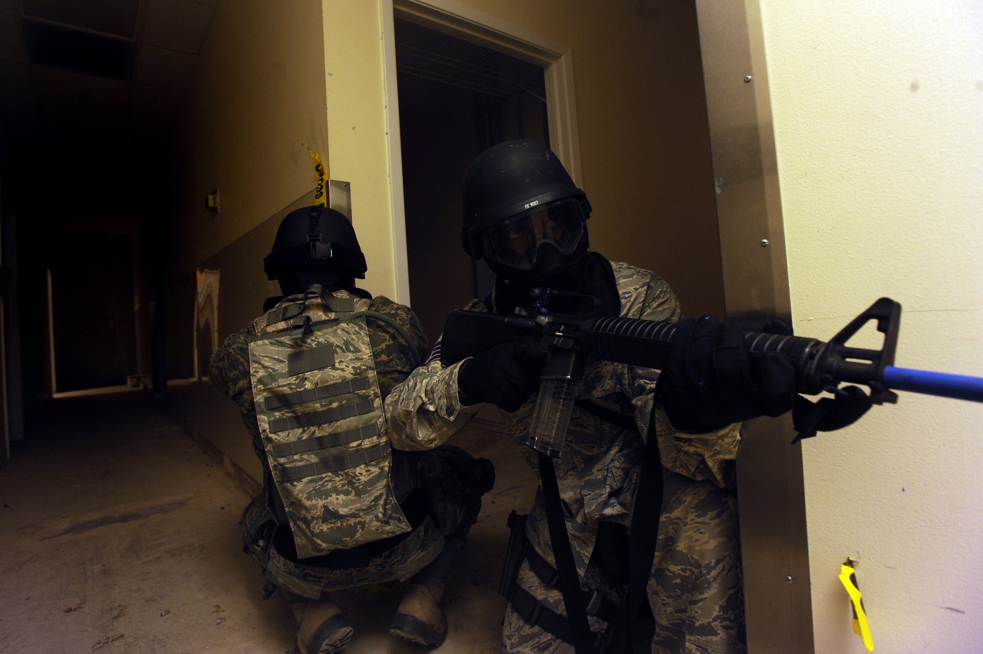 Airmen from the 1st Special Operations Wing Security Forces Squadron secure a hallway during active shooter training at a training building in Okaloosa County, Fla., July 22, 2010. More than 15 1st SOSFS members took part in the training, which was conducted alongside members of the Fort Walton Beach Police Department. (DoD photo by U. S. Air Force Senior Airman Matthew Loken)