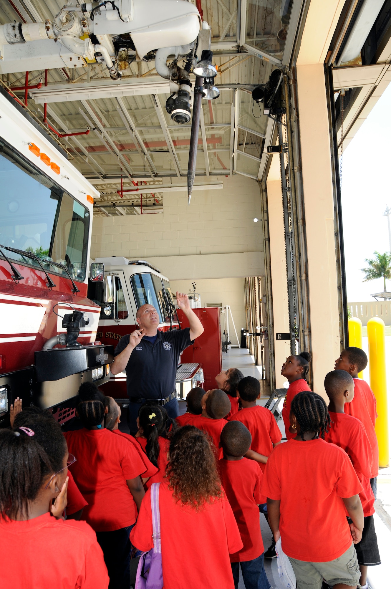 Homestead ARB firefighter Mr. Todd Bassett explains the operation of a penetrator nozzle on a T-1500 fire truck to kids from the Miami-Dade YWCA during a tour of the base fire station on July 27. Over 50 kids and adults from the YWCA summer camp program toured the station and watched demonstrations of various firefighting equipment.  Base tours are conducted by the 482nd Fighter Wing public affairs office twice a month. (U.S. Air Force photo/Tim Norton) 