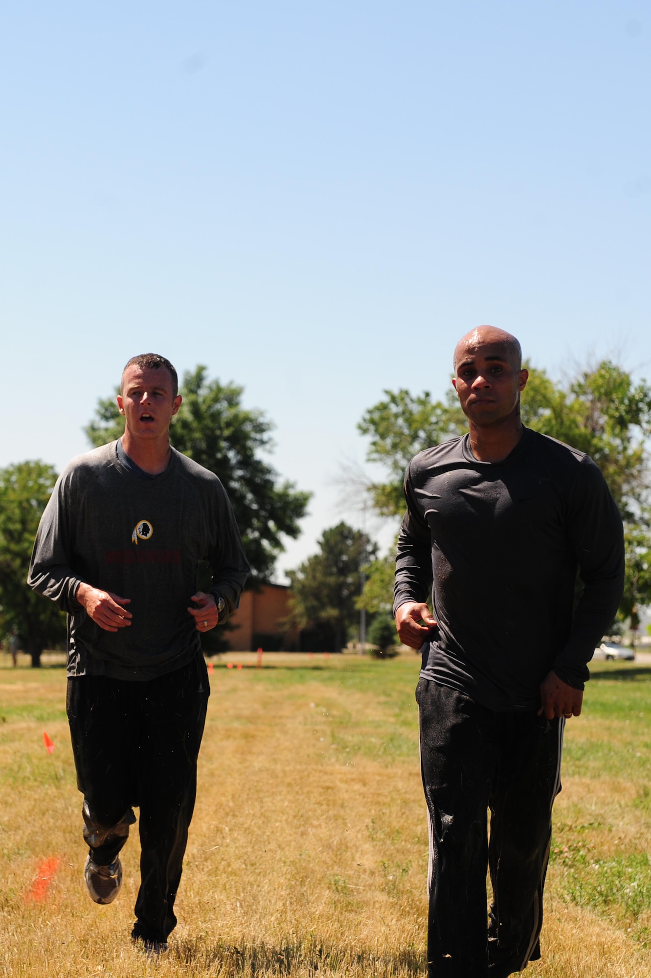 ELLSWORTH AIR FORCE BASE, S.D. - (Left) Capt. Chris Newton, 28th Bomb Wing assistant staff judge advocate, and Staff Sgt. Toribio Garcia, 28th Bomb Wing paralegal, finish first in the Ultimate Challenge during the base picnic, July 23. The challenge included nearly twenty teams consisting of Airmen, civilians and spouses. (U.S. Air Force photo/Airman 1st Class Corey Hook)
