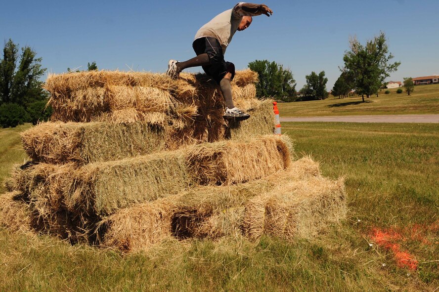 ELLSWORTH AIR FORCE BASE, S.D. - Staff Sgt. Junyville Gianan, 28th Logistics Readiness Squadron control center support supervisor, participates in the Ultimate Challenge during the base picnic, July 23. During the challenge participants ran an off-road 5k course while performing low crawl, dizzy bat and leap frog obstacles among others. (U.S. Air Force photo/Airman 1st Class Corey Hook)