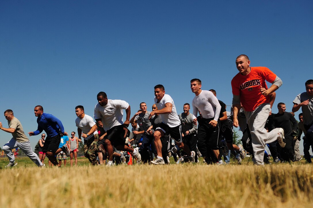 ELLSWORTH AIR FORCE BASE, S.D. - Community members of Ellsworth Air Force Base compete in the Ultimate Challenge during the base picnic, July 23. The Ultimate Challenge, hosted by the Airman and Family Readiness Center, is a 5k run with various obstacles for competing teams of two. (U.S. Air Force photo/Airman 1st Class Corey Hook)