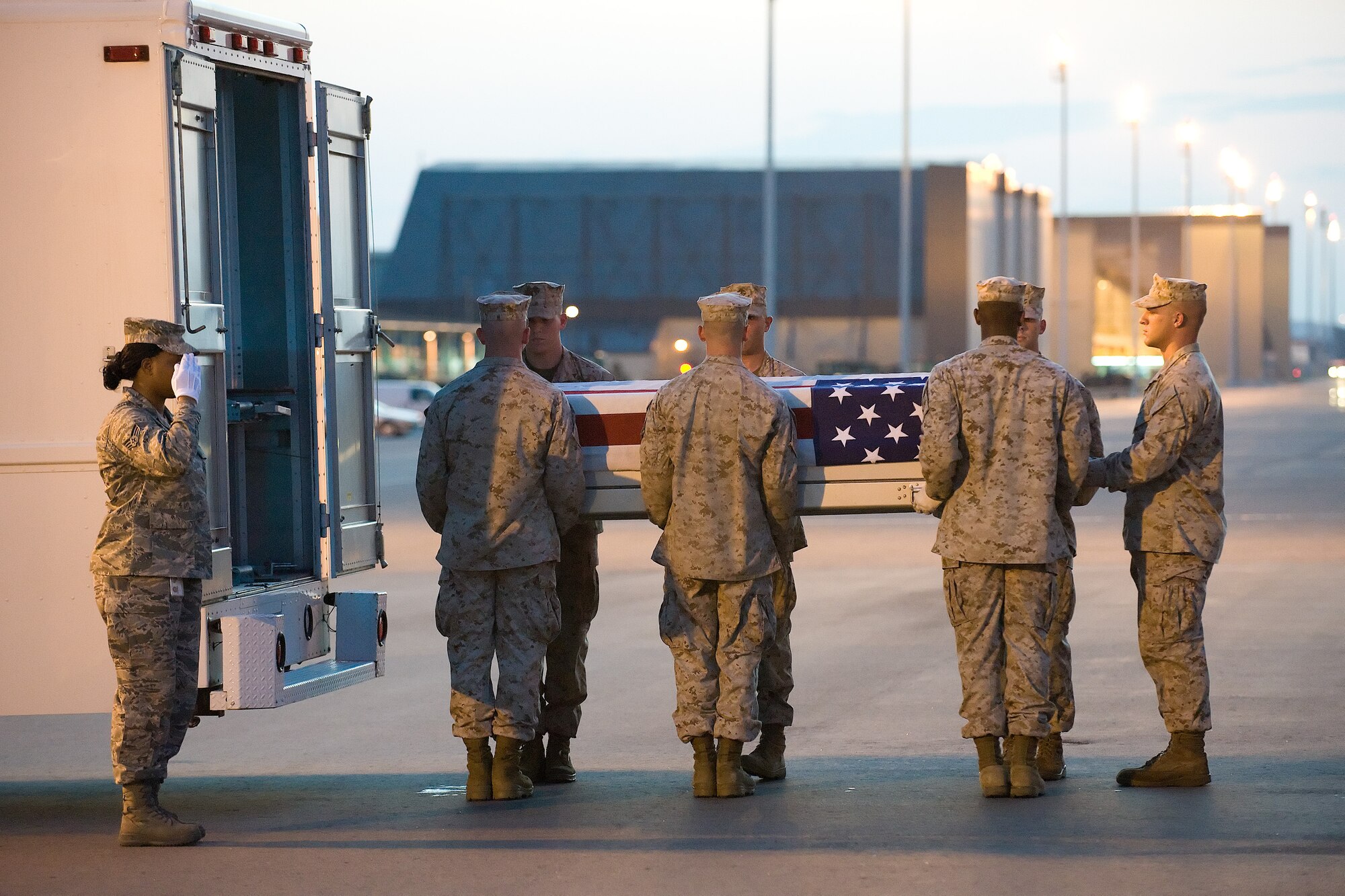 21 July 2010  USAF Photo by Jason Minto.  A U.S. Marine Corps carry team transfers the remains of Marine Cpl Joe L. Wrightsman of Jonesboro, LA., at Dover Air Force Base, Del., July 21, 2010.  