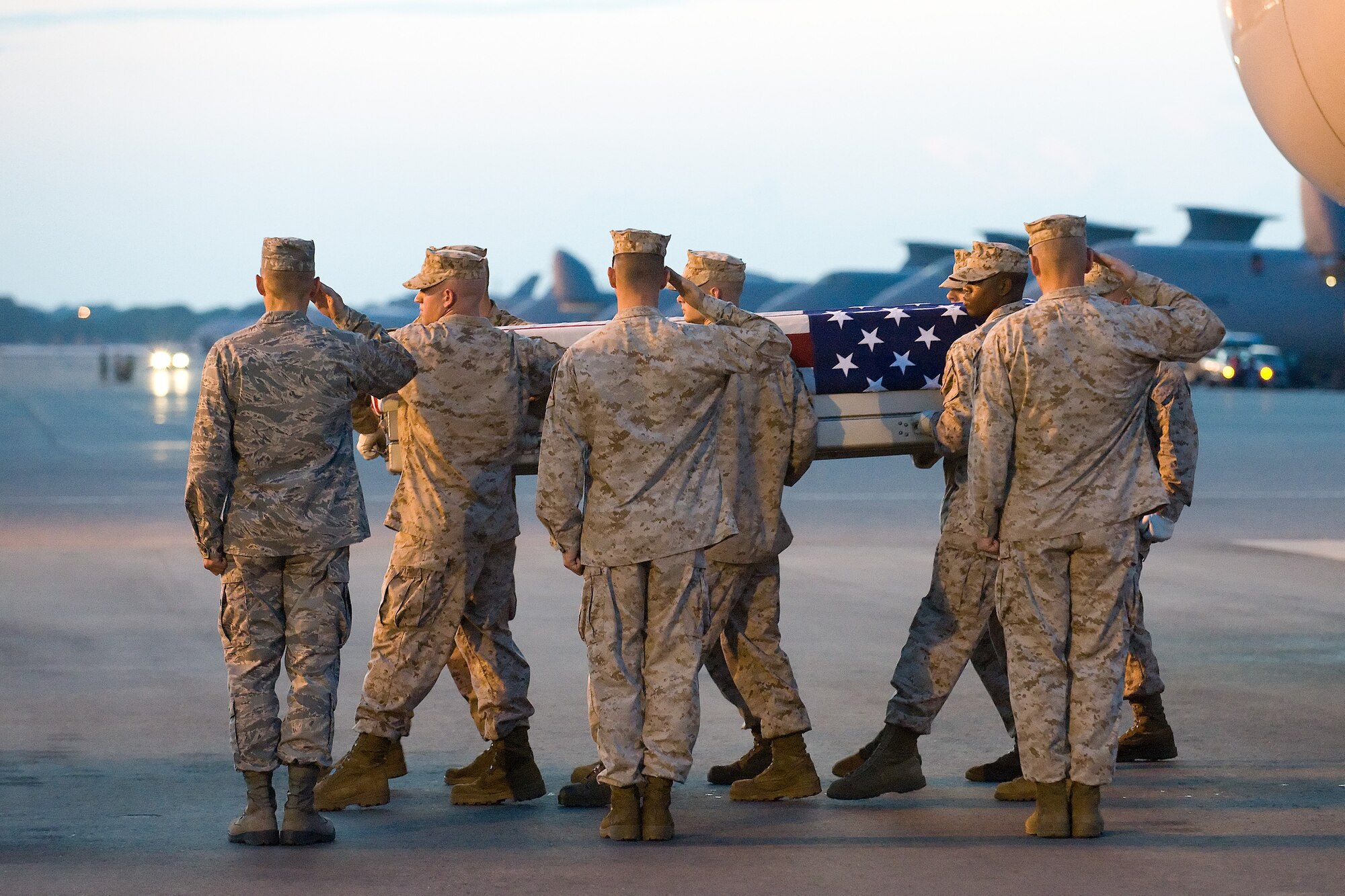 21 July 2010  USAF Photo by Jason Minto.  A U.S. Marine Corps carry team transfers the remains of Marine Cpl Paul J. Miller of Traverse City, MI., at Dover Air Force Base, Del., July 21, 2010.  