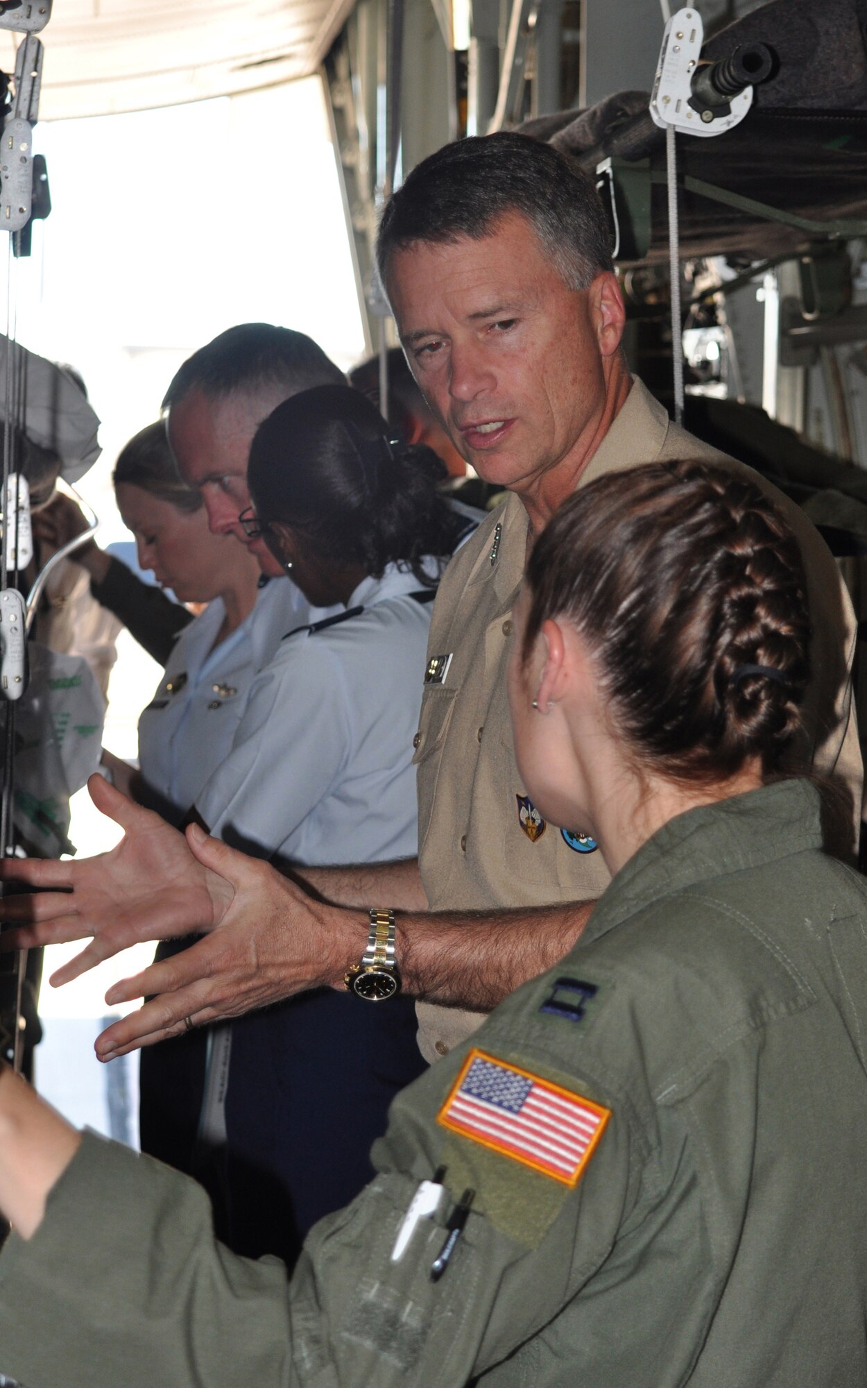 Navy Adm. James A. Winnefeld, Jr., discusses the challenges of aeromedical evacuation with Capt. Carrie Williamson (foreground) July 26 at Peterson Air Force Base, Colo. Admiral Winnefeld, commander of both the North American Aerospace Defense Command and U.S. Northern Command, together with senior leaders from both commands, visited the Air Force Reserve’s 302nd Airlift Wing to gain a better understanding of the specialized missions the AF Reserve supports, to include aeromedical evacuation and aerial firefighting. The visit also showcased the capabilities Air Force Reservists can provide to civilian-related missions if called upon. Captain Williamson is flight nurse and Air Reserve Technician within the 302nd AW. (U.S. Air Force photo/Staff Sgt. Stephen J. Collier)