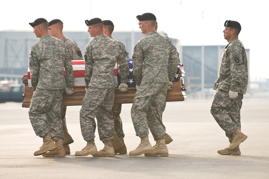 A U.S. Army carry team transfers the remains of Army Pfc. Jacob A. Dennis, of Powder Springs, Ga., at Dover Air Force Base, Del., July 17, 2010. Dennis was assigned to the 4th Battalion, 23rd Infantry Regiment, 5th Stryker Brigade, 2nd Infantry Division, Joint Base Lewis-McChord, Wash. He died July 3 at Landstuhl Regional Medical Center, Landstuhl, Germany, of injuries sustained June 30 in a weapons system accident at Forward Operating Base Lane, Afghanistan. (U.S. Air Force photo/Roland Balik) 
