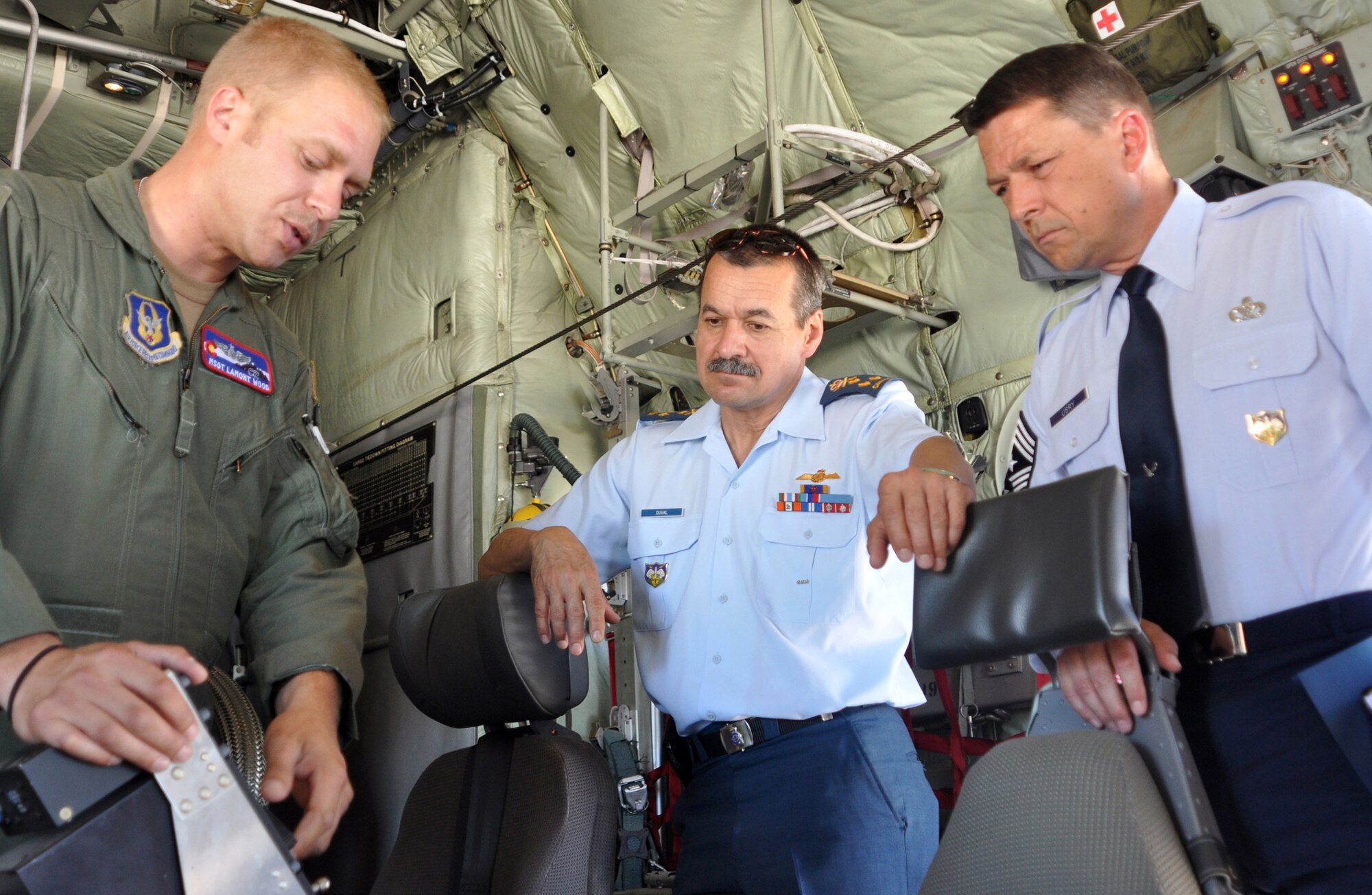 Master Sgt. Lamont Wood (left) explains the layout of a Modular Airborne Firefighting System II control panel to Canadian Lt. Gen. J.M. Duval (center) and Chief Master Sgt. W. Allen Usry during a 302nd Airlift Wing-sponsored presentation on Air Force Reserve missions to senior North American Aerospace Defense Command and U.S. Northern Command officials July 26 at Peterson Air Force Base, Colo. The visit, headlined by Navy Adm. James A. Winnefeld, Jr., NORAD and USNORTHCOM commander, helped to give the senior leaders a better understanding of the specialized missions the AF Reserve supports, as well as the capabilities it can provide to civilian-related missions if called upon. General Duval is the NORAD deputy commander, and Chief Usry is the senior enlisted advisor for NORAD and USNORTHCOM. Sergeant Wood is a C-130 Hercules loadmaster within the 302nd AW. (U.S. Air Force photo/Staff Sgt. Stephen J. Collier)
