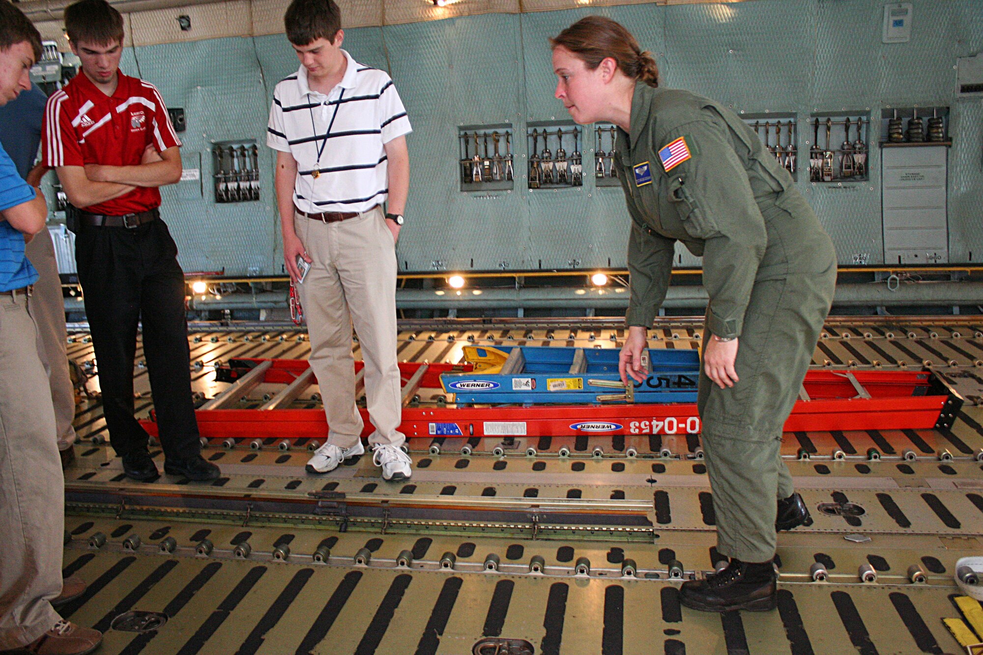 WRIGHT-PATTERSON AIR FORCE BASE, Ohio –Tech. Sgt. Caroline Sussman, 89th Airlift Squadron, shows students from the Wright Scholars program the cargo area of a 445th Airlift Wing C-5 Galaxy. Twenty five students participating in the program toured the C-5 to get a better understanding of the role of the aircraft as part of their orientation to the base July 23. (U.S. Air Force photo/Senior Airman Mikhail Berlin)
