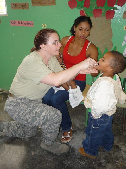 First Lt. Marylou Cowles, 512th Aerospace Medicine Squadron, medicates a patient in the Dominican Republic during a medical readiness training exercise July 10-24. Thirty-nine Air Force Reserve medics with the 512th AMDS here flew to Central America as part of MEDRETE 2010 Dominican Republic. The 512th Airlift Wing Airmen and a team of doctors from the Dominican military provided free medical care to more than 8,000 citizens of Constanza. (U.S. Air Force photo/Tech. Sgt. Jennifer Hinshaw)