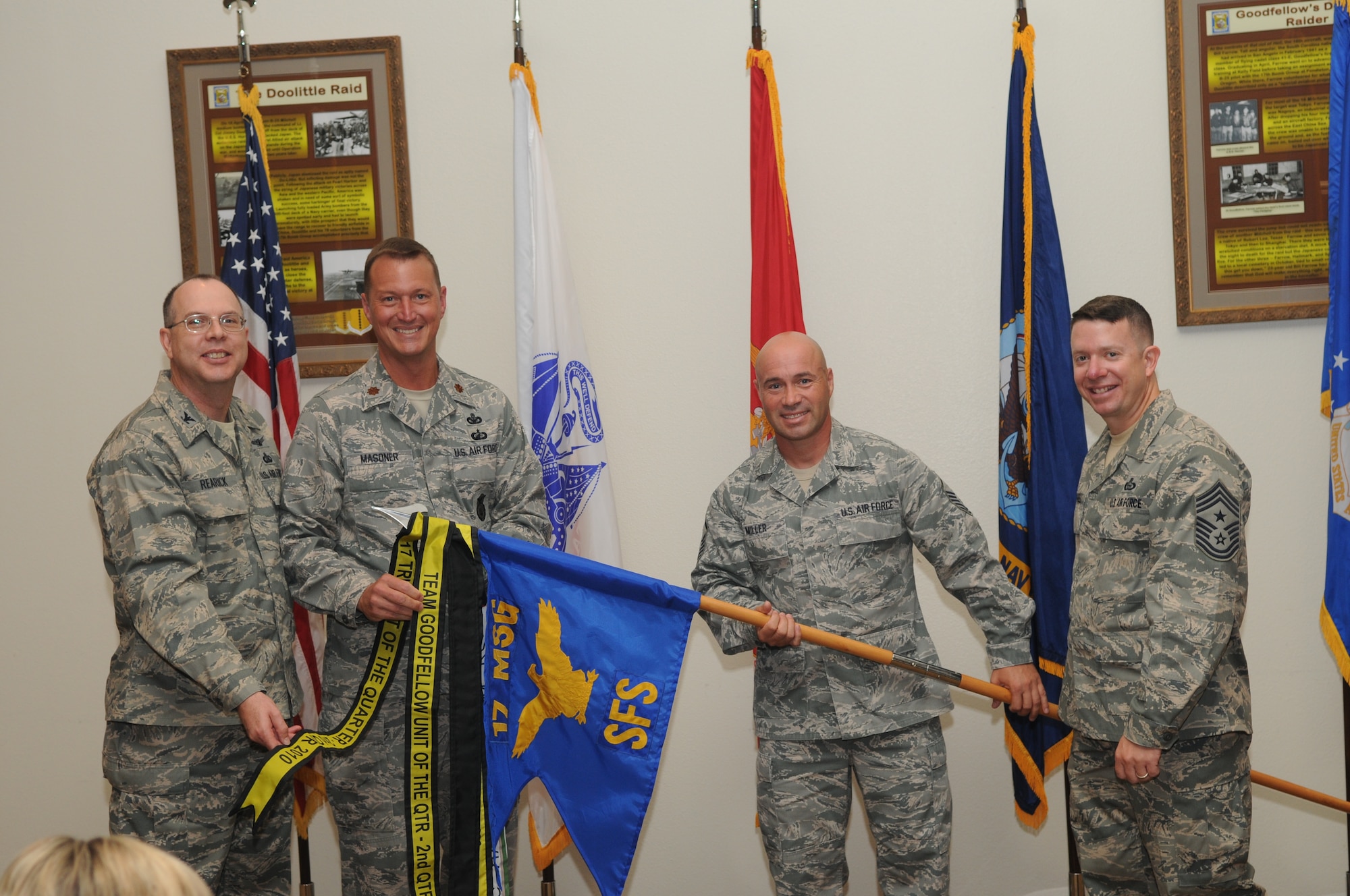 GOODFELLOW AIR FORCE BASE, Texas -- Maj. James Masoner, 17th Security Forces Squadron, and Master Sgt. Michael Miller, 17th SFS first sergeant, receive the 17th Training Wing and Team Goodfellow Unit of the Quarter awards during the wing quarterly award ceremony July 27. (U.S. Air Force photo/Airman 1st Class Clayton Lenhardt) 