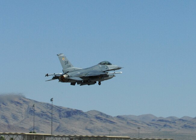 NELLIS AIR FORCE BASE, Nev. -- An F-16 from the 77th Fighter Squadron, Shaw Air Force Base, S.C. takes off from the runway for Red Flag-Nellis July 21, 2010. Red Flag is a realistic combat training exercise involving the air forces of the United States and its allies. The exercise is hosted north of Las Vegas on the Nevada Test and Training Range--the U.S. Air Force's premier military training area with more than 12,000 square miles of airspace and 2.9 million acres of land. With 1,900 possible targets, realistic threat systems and an opposing enemy force that cannot be replicated anywhere else in the world, Nellis and the NTTR are the home of a "peacetime battlefield," providing combat air forces with the ability to train to fly, fight and win together. (U.S. Air Force photo by Airman 1st Class Daniel Phelps)