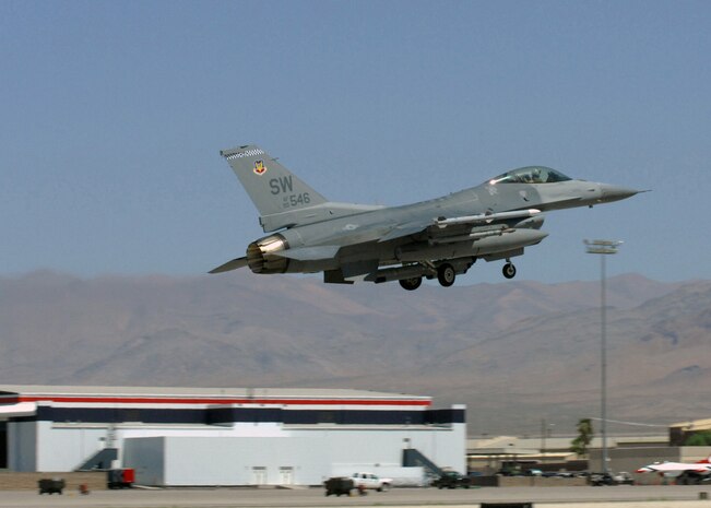 NELLIS AIR FORCE BASE, Nev. -- An F-16 from the 77th Fighter Squadron, Shaw Air Force Base, S.C. takes off from the runway for Red Flag-Nellis July 21, 2010. Red Flag is a realistic combat training exercise involving the air forces of the United States and its allies. The exercise is hosted north of Las Vegas on the Nevada Test and Training Range--the U.S. Air Force's premier military training area with more than 12,000 square miles of airspace and 2.9 million acres of land. With 1,900 possible targets, realistic threat systems and an opposing enemy force that cannot be replicated anywhere else in the world, Nellis and the NTTR are the home of a "peacetime battlefield," providing combat air forces with the ability to train to fly, fight and win together. (U.S. Air Force photo by Airman 1st Class Daniel Phelps)