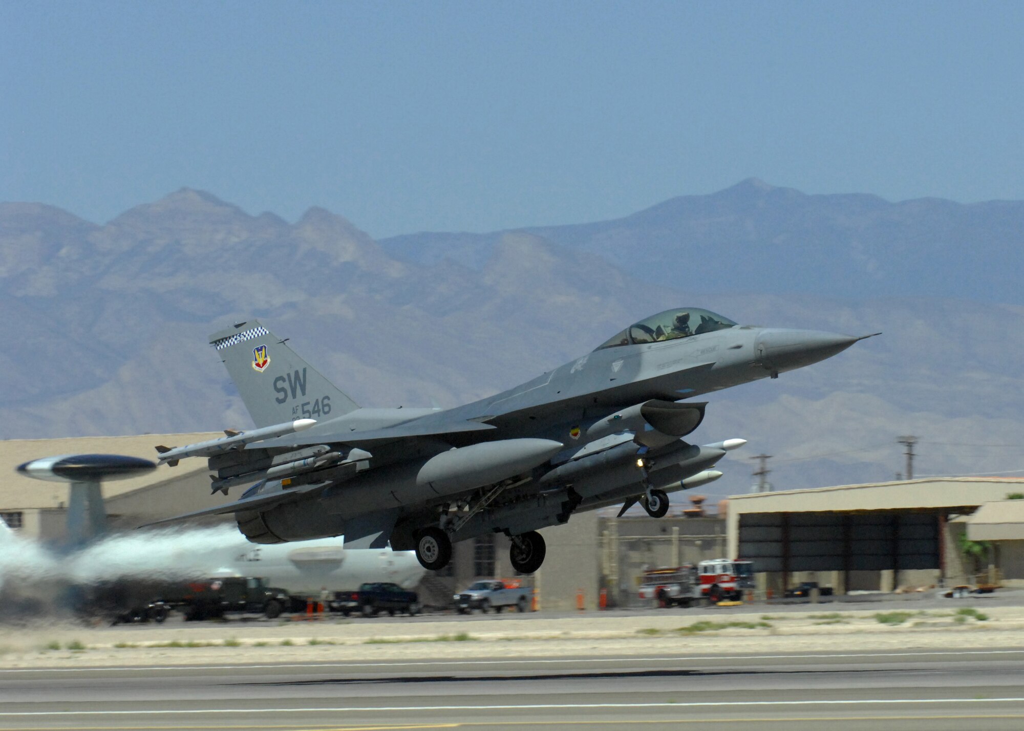 NELLIS AIR FORCE BASE, Nev. -- An F-16 from the 77th Fighter Squadron, Shaw Air Force Base, S.C. takes off from the runway for Red Flag-Nellis July 21, 2010. Red Flag is a realistic combat training exercise involving the air forces of the United States and its allies. The exercise is hosted north of Las Vegas on the Nevada Test and Training Range--the U.S. Air Force's premier military training area with more than 12,000 square miles of airspace and 2.9 million acres of land. With 1,900 possible targets, realistic threat systems and an opposing enemy force that cannot be replicated anywhere else in the world, Nellis and the NTTR are the home of a "peacetime battlefield," providing combat air forces with the ability to train to fly, fight and win together. (U.S. Air Force photo by Airman 1st Class Daniel Phelps)