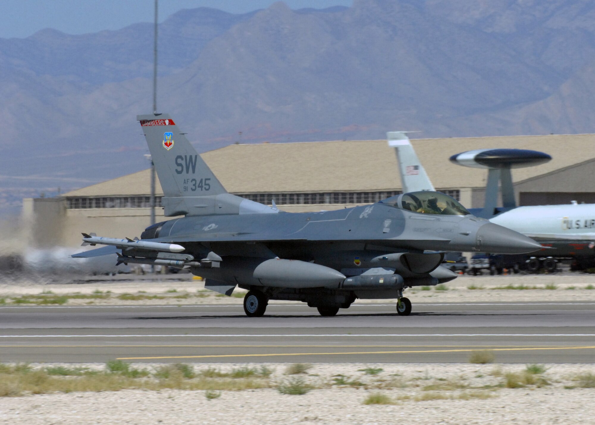 NELLIS AIR FORCE BASE, Nev. -- An F-16 from the 77th Fighter Squadron, Shaw Air Force Base, S.C. takes off from the runway for Red Flag-Nellis July 21, 2010. Red Flag is a realistic combat training exercise involving the air forces of the United States and its allies. The exercise is hosted north of Las Vegas on the Nevada Test and Training Range--the U.S. Air Force's premier military training area with more than 12,000 square miles of airspace and 2.9 million acres of land. With 1,900 possible targets, realistic threat systems and an opposing enemy force that cannot be replicated anywhere else in the world, Nellis and the NTTR are the home of a "peacetime battlefield," providing combat air forces with the ability to train to fly, fight and win together. (U.S. Air Force photo by Airman 1st Class Daniel Phelps)