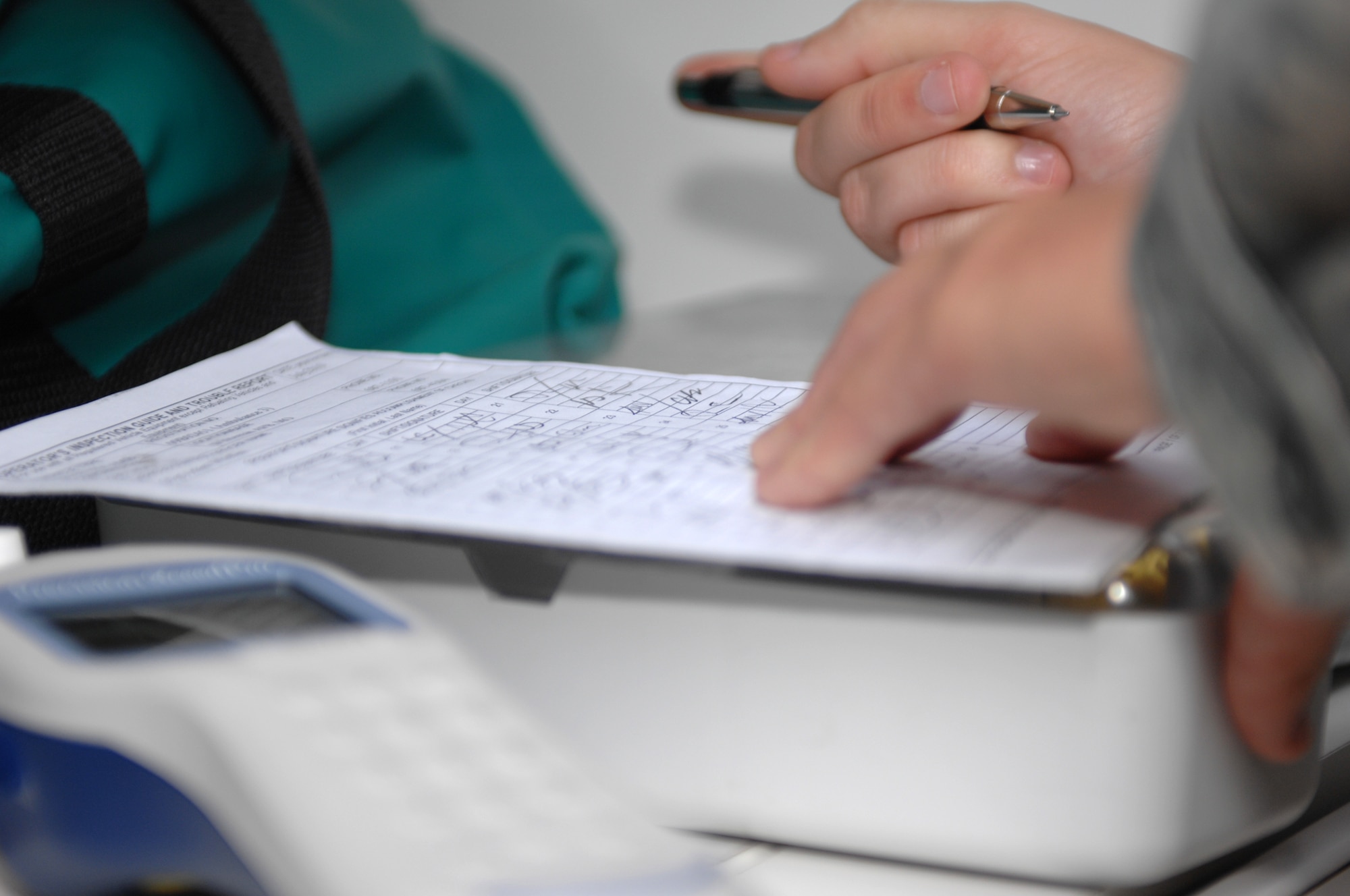 Senior Airman Melissa L. Lerch, 509th Medical Operations Squadron ambulance services technician, signs a checklist ensuring an ambulance is completely service-ready for the on-coming shift. The engine, equipment, and all compartments are checked before signing. (U.S. Air Force photo by Airman 1st Class Cody H. Ramirez) (Released)