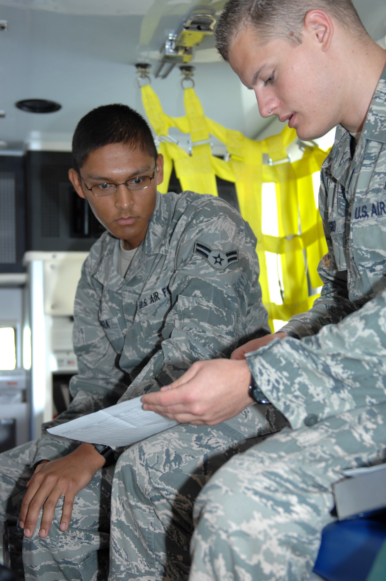 WHITEMAN AIR FORCE BASE, Mo.,- Senior Airman Jacob Rosko,509th Medical Operations Squadron ambulance service technician, trains Airman 1st Class Matthew Mendoza, 509th Medical Squadron ambulance service technician, on the morning ambulance checklist July 27. The team checks all equipment at the start of every shift. (U.S. Air Force photo by Airman 1st Class Cody H. Ramirez) (Released)
