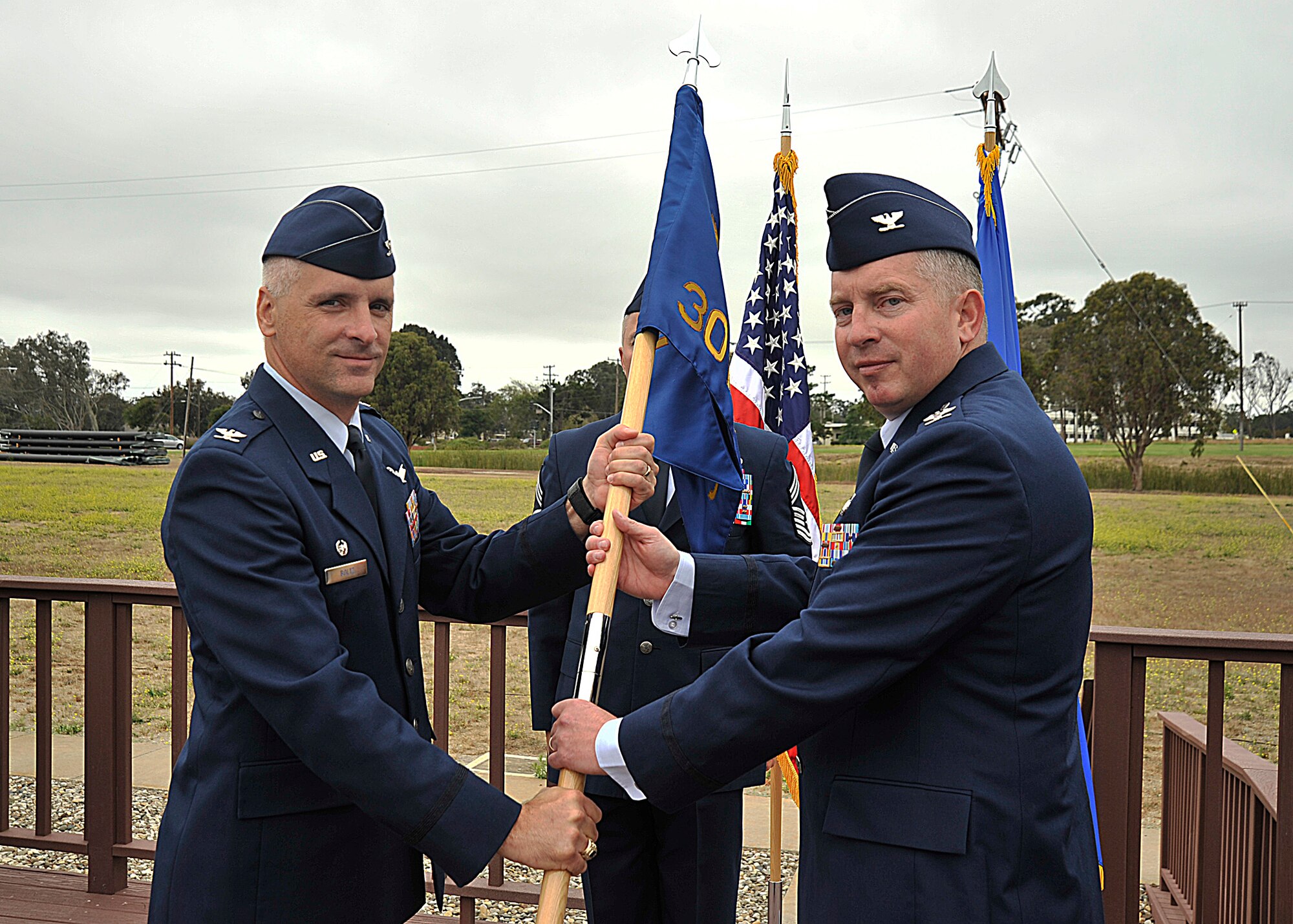 VANDNEBERG AIR FORCE BASE, Calif.-- Col. Kelly Kirts, the incoming 30th Mission Support Group commander, assumes command as he accepts the guidon flag from 30th Space Wing commander Col. Richard Boltz, during the change of command ceremony here Monday, July 26, 2010. Colonel Kirts will  command 26 30th Space Wing organizations, 18 associate units, 45 contractors and more than 10,000 people..(U.S. Air Force Photo/Senior Airman Stephanie Longoria)