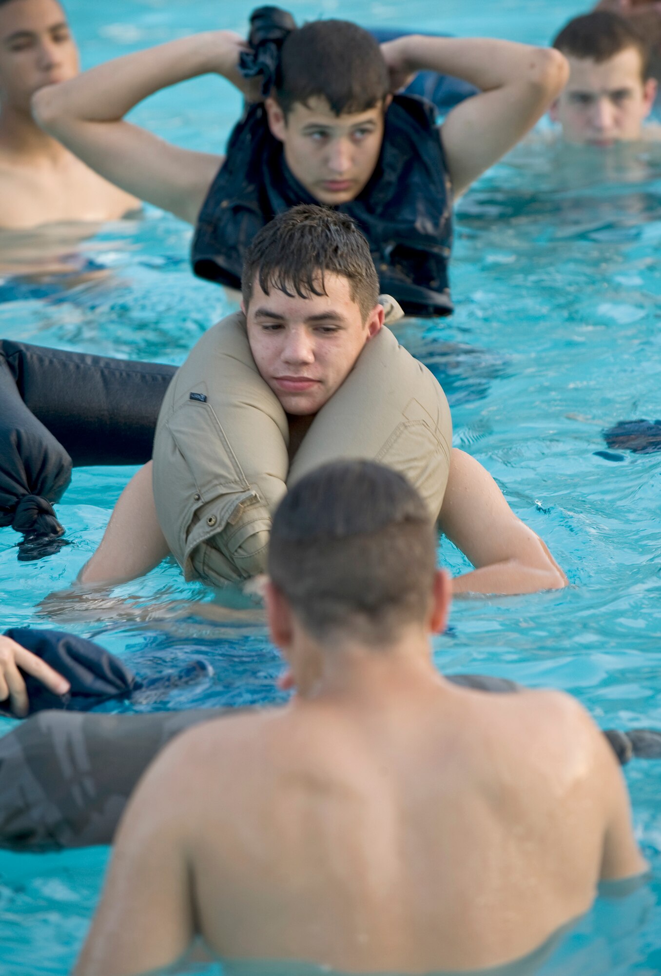 Civil Air Patrol cadets practice using pants as an improvised floatation device during a water survival course hosted by 2nd Operations Support Squadron Survival, Evasion, Resistance and Escape specialists July 21, 2010, at Barksdale Air Force Base, La. The course was part of the annual CAP Louisiana Wing Cadet Encampment held here July 15 through 25. (U.S. Air Force photo/Senior Airman Chad Warren) 