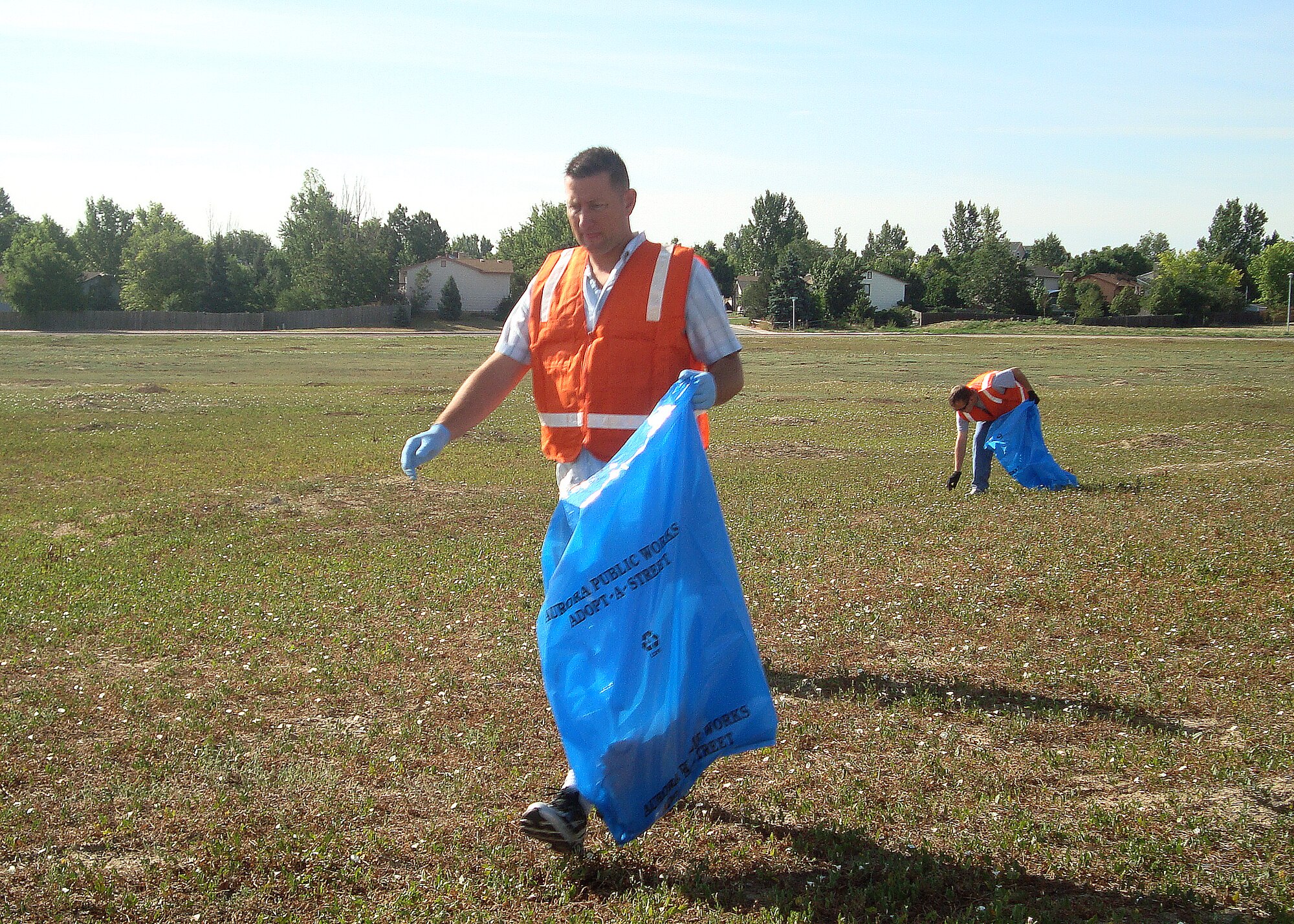 AURORA, Colo. -- Tech. Sgt. Scott McNabb, a volunteer from the 460th Space Wing, picks up litter from the side of Tower Road July 24. Volunteers from Team Buckley as well as Air Force Sergeants Association Chapter 1179 came together to keep the road clean during the volunteer event. (U.S. Air Force photo by Airman 1st Class Marcy Glass)