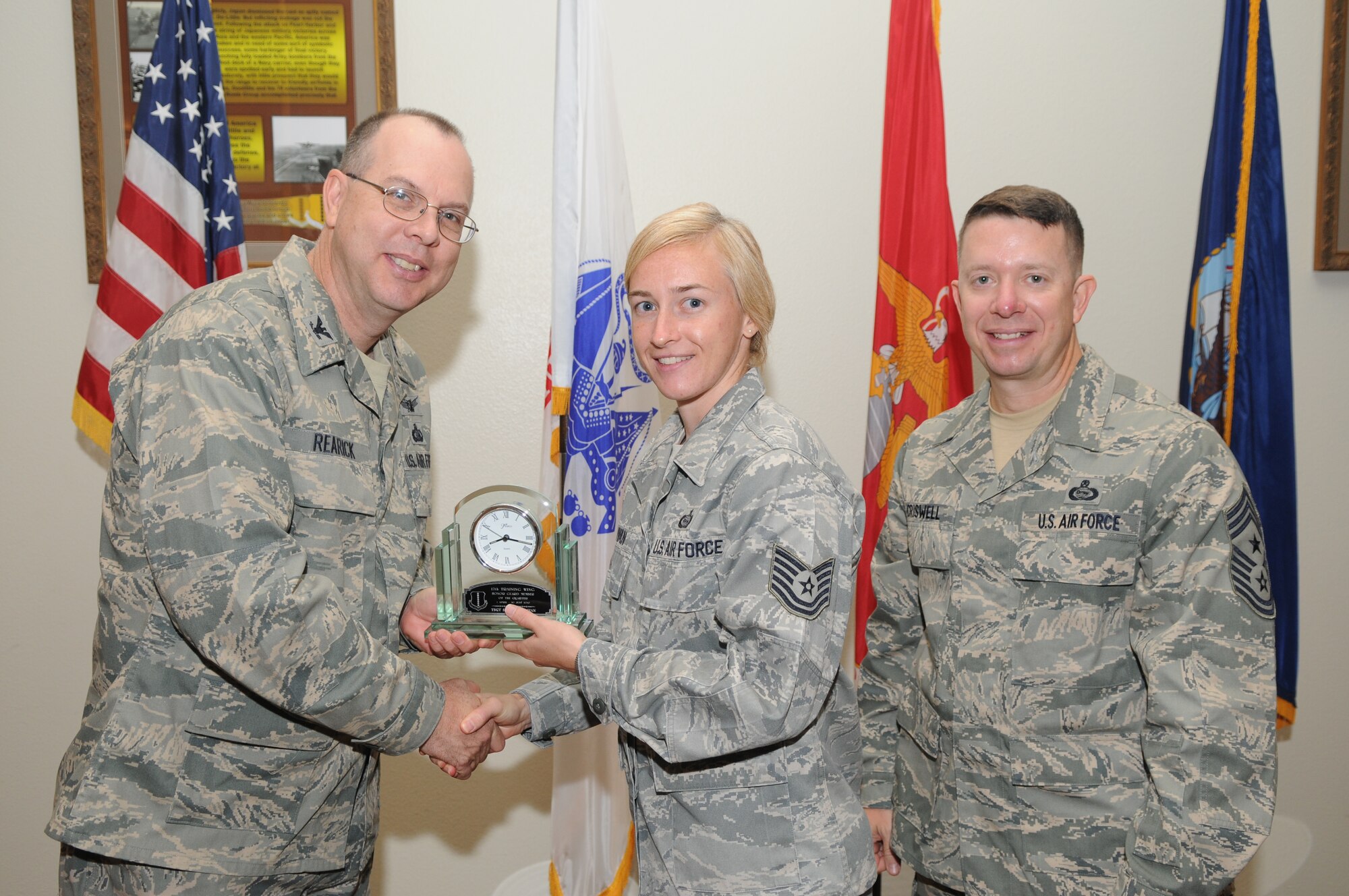 GOODFELLOW AIR FORCE BASE, Texas -- Tech. Sgt. Sarah Sullivan, 17th Training Group, receives 17th Training Wing Honor Guard Member of the Quarter during the wing quarterly awards ceremony July 27. (U.S. Air Force photo/Airman 1st Class Clayton Lenhardt) 