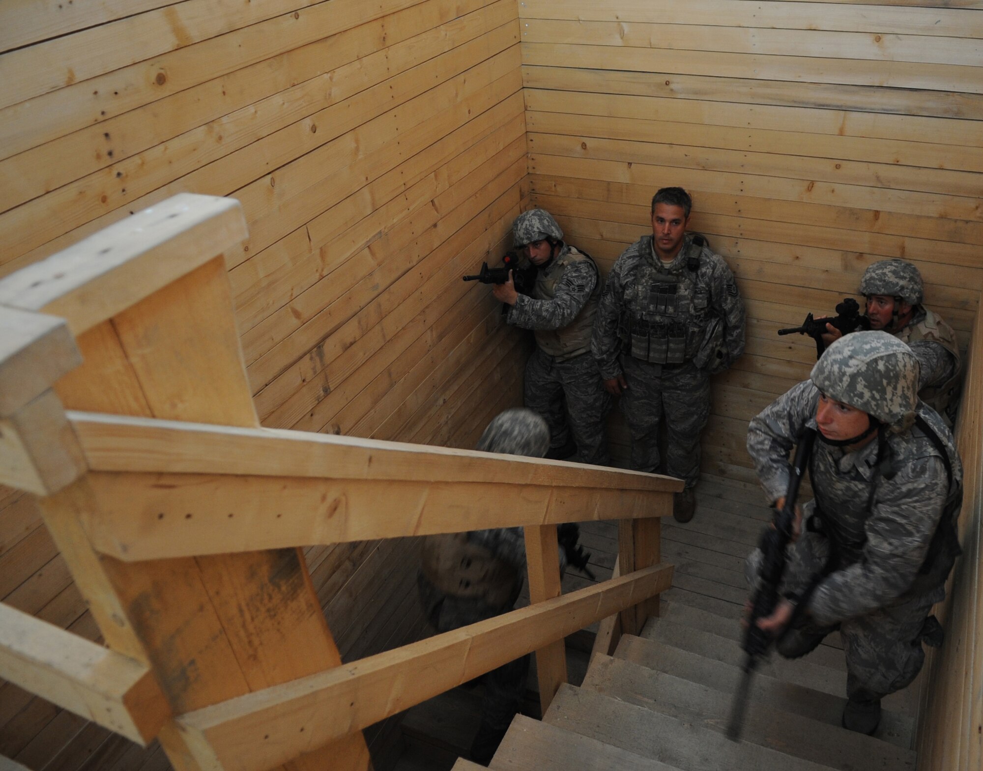 U.S. Air Force Tech. Sgt. Shawn Leonard, 9th Air Support Operations Squadron joint terminal attack controller instructor, Fort Hood, Texas, observes Airmen clear a stairwell in urban close combat training class during exercise ALLIED STRIKE 10, Grafenwoehr, Germany, July 26, 2010. AS 10 is Europe's premier close air support (CAS) exercise, held annually to conduct robust, realistic CAS training that helps build partnership capacity among allied North Atlantic Treaty Organization nations and joint services while refining the latest operational CAS tactics. For more ALLIED STRIKE information go to www.usafe.af.mil/alliedstrike.asp. (U.S. Air Force photo by Senior Airman Caleb Pierce)