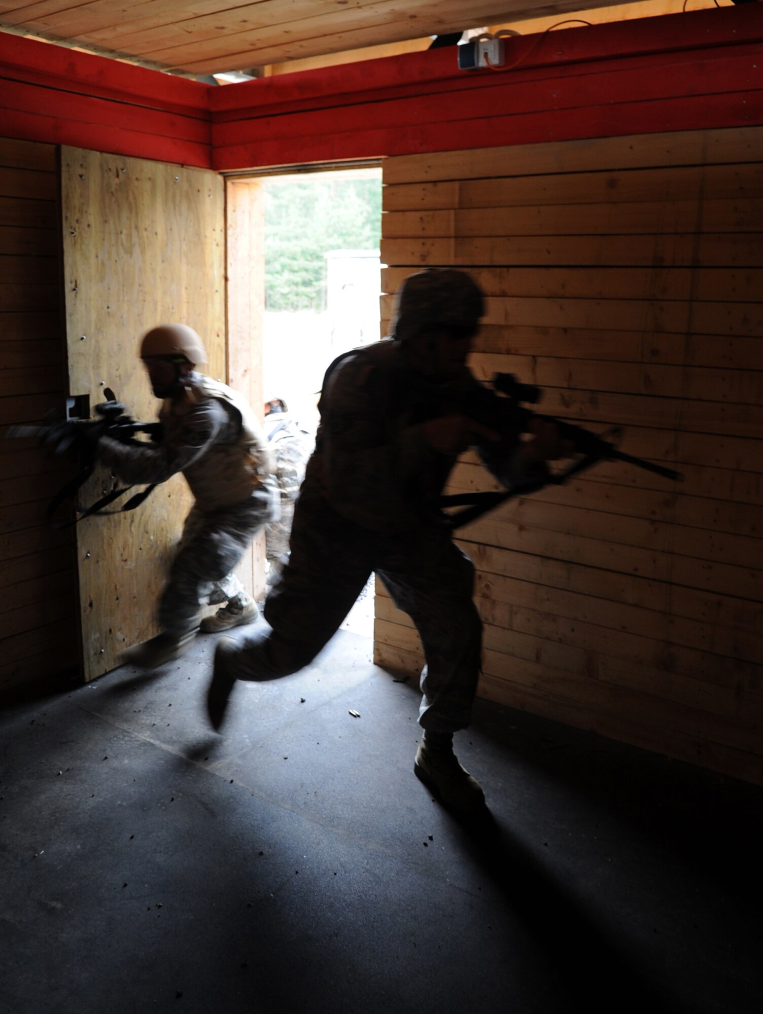 U.S. Air Force Airmen participate in an urban close combat training scenerio, clear a building during exercise ALLIED STRIKE 10, Grafenwoehr, Germany, July 26, 2010. AS 10 is Europe's premier close air support (CAS) exercise, held annually to conduct robust, realistic CAS training that helps build partnership capacity among allied North Atlantic Treaty Organization nations and joint services while refining the latest operational CAS tactics. For more ALLIED STRIKE information go to www.usafe.af.mil/alliedstrike.asp. (U.S. Air Force photo by Senior Airman Caleb Pierce)