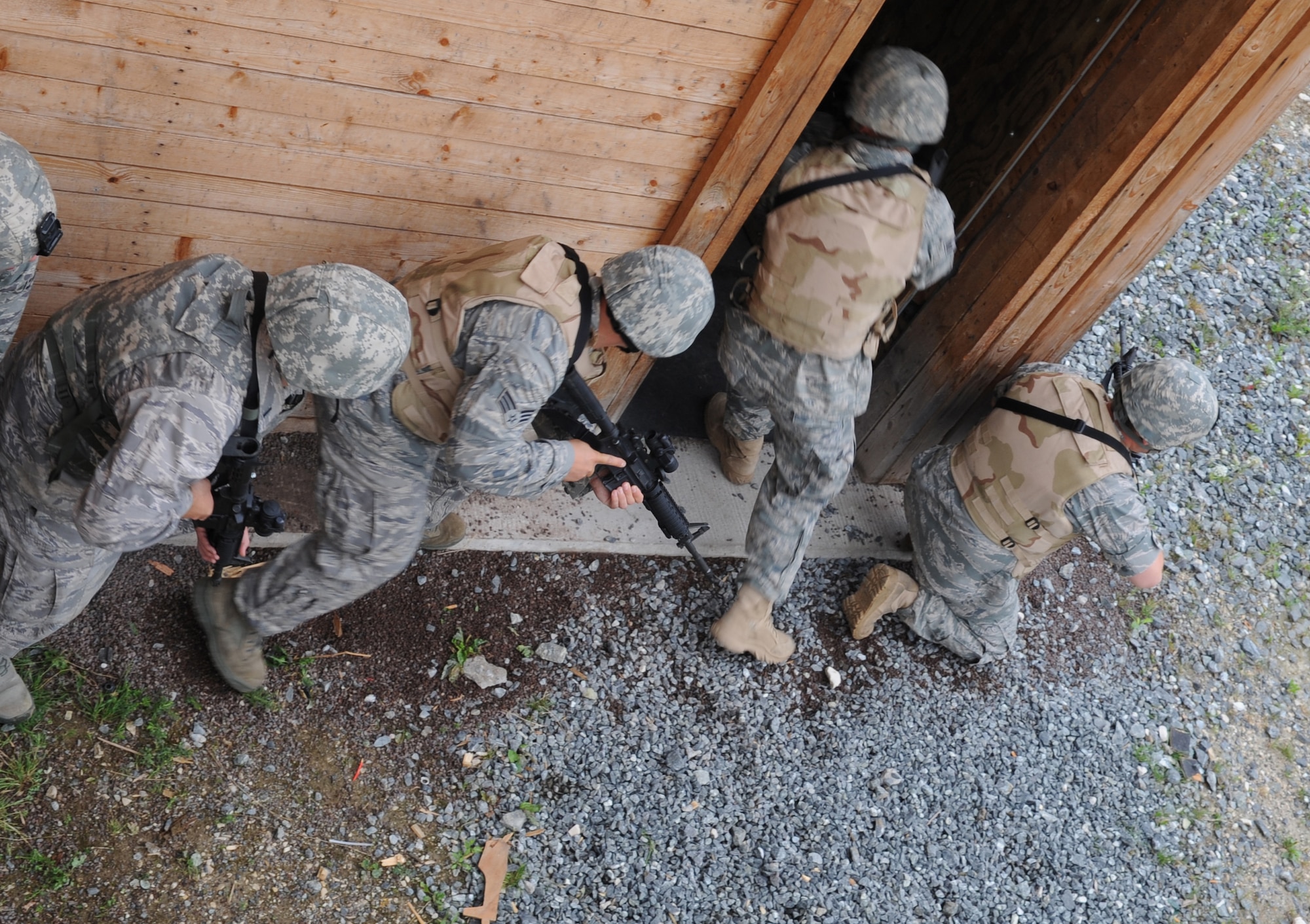 U.S. Air Force Airmen participating in urban close combat training clear a building during exercise ALLIED STRIKE 10, Grafenwoehr, Germany, July 26, 2010. AS 10 is Europe's premier close air support (CAS) exercise, held annually to conduct robust, realistic CAS training that helps build partnership capacity among allied North Atlantic Treaty Organization nations and joint services while refining the latest operational CAS tactics. For more ALLIED STRIKE information go to www.usafe.af.mil/alliedstrike.asp. (U.S. Air Force photo by Senior Airman Caleb Pierce)