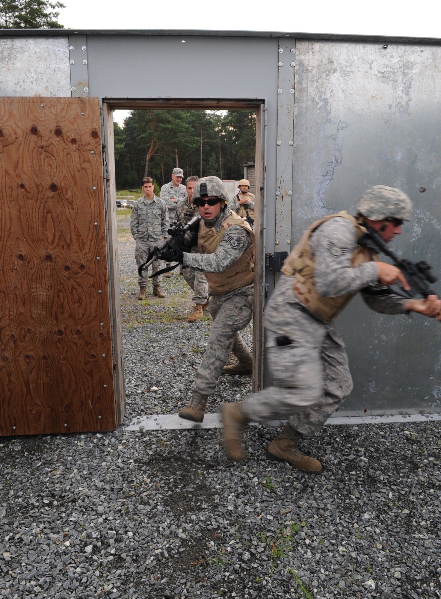 U.S. Air Force Airmen participating in urban close combat training clear a building during exercise ALLIED STRIKE 10, Grafenwoehr, Germany, July 26, 2010. AS 10 is Europe's premier close air support (CAS) exercise, held annually to conduct robust, realistic CAS training that helps build partnership capacity among allied North Atlantic Treaty Organization nations and joint services while refining the latest operational CAS tactics. For more ALLIED STRIKE Strike information go to www.usafe.af.mil/alliedstrike.asp. (U.S. Air Force photo by Senior Airman Caleb Pierce)