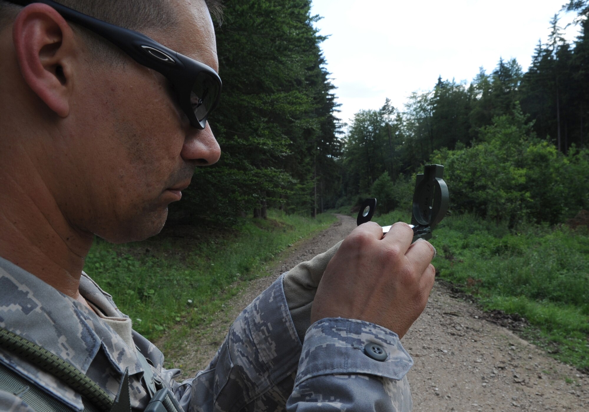 U.S. Air Force Master Sgt. Richard Ribeiro, 4th Air Support Operations Group knowledge operations manager, Campbell Barracks Heidelberg, Germany, uses a compass  to find help find the next way point for a land navigation course during exercise ALLIED STRIKE 10, Grafenwoehr, Germany, July 25, 2010. AS 10 is Europe's premier close air support (CAS) exercise, held annually to conduct robust, realistic CAS training that helps build partnership capacity among allied North Atlantic Treaty Organization nations and joint services while refining the latest operational CAS tactics. For more ALLIED STRIKE information go to www.usafe.af.mil/alliedstrike.asp. (U.S. Air Force photo by Senior Airman Caleb Pierce)