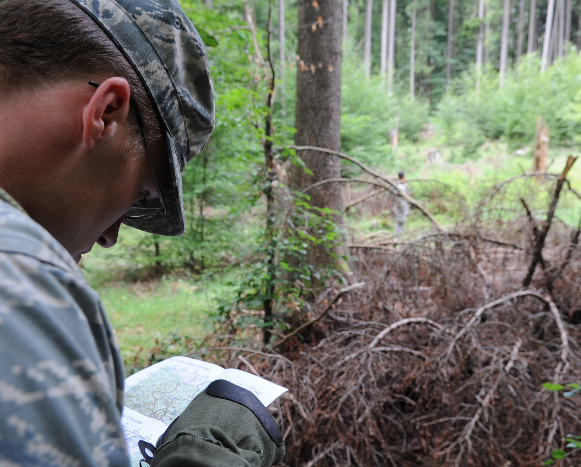 U.S. 1st Lt. John Dunn, 4th Air Support Operations Group intelligence officer from Camel Barracks Heidelberg, checks grids on a map for a land navigation course during exercise ALLIED STRIKE 10, Grafenwoehr, Germany, July 25, 2010. AS 10 is Europe's premier close air support (CAS) exercise, held annually to conduct robust, realistic CAS training that helps build partnership capacity among allied North Atlantic Treaty Organization nations and joint services while refining the latest operational CAS tactics. For more ALLIED STRIKE information go to www.usafe.af.mil/alliedstrike.asp. (U.S. Air Force photo by Senior Airman Caleb Pierce)