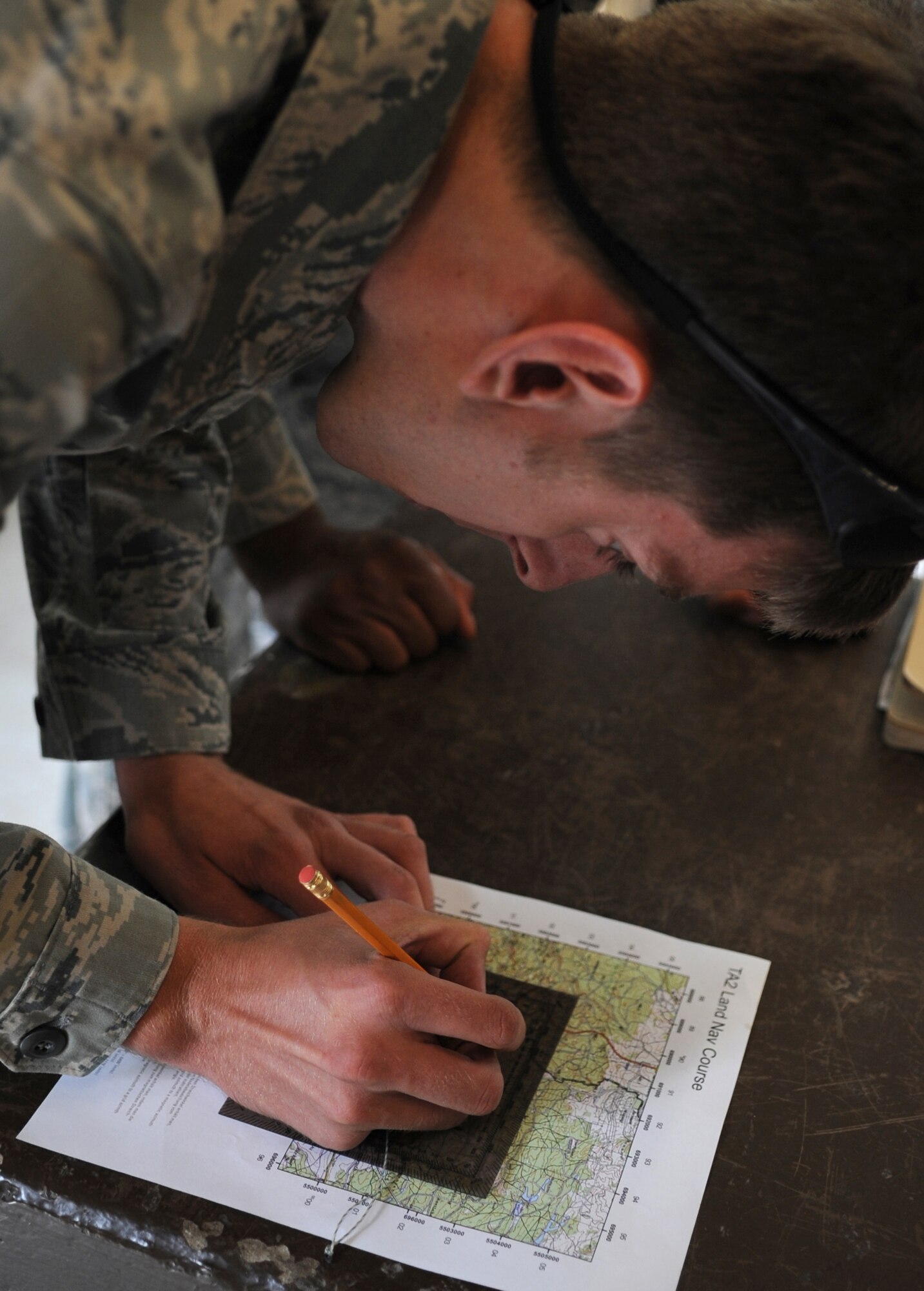 U.S. Air Force Staff Sgt. Nicholas Nelson, 8th Air Support Operations Squadron radio frequency transmission journeyman stationed at Aviano Air Base, Italy, plots way points on a map for a land navigation course during exercise ALLIED STRIKE 10, Grafenwoehr, Germany, July 25, 2010. AS 10 is Europe's premier close air support (CAS) exercise, held annually to conduct robust, realistic CAS training that helps build partnership capacity among allied North Atlantic Treaty Organization nations and joint services while refining the latest operational CAS tactics. For more ALLIED STRIKE information go to www.usafe.af.mil/alliedstrike.asp. (U.S. Air Force photo by Senior Airman Caleb Pierce) 