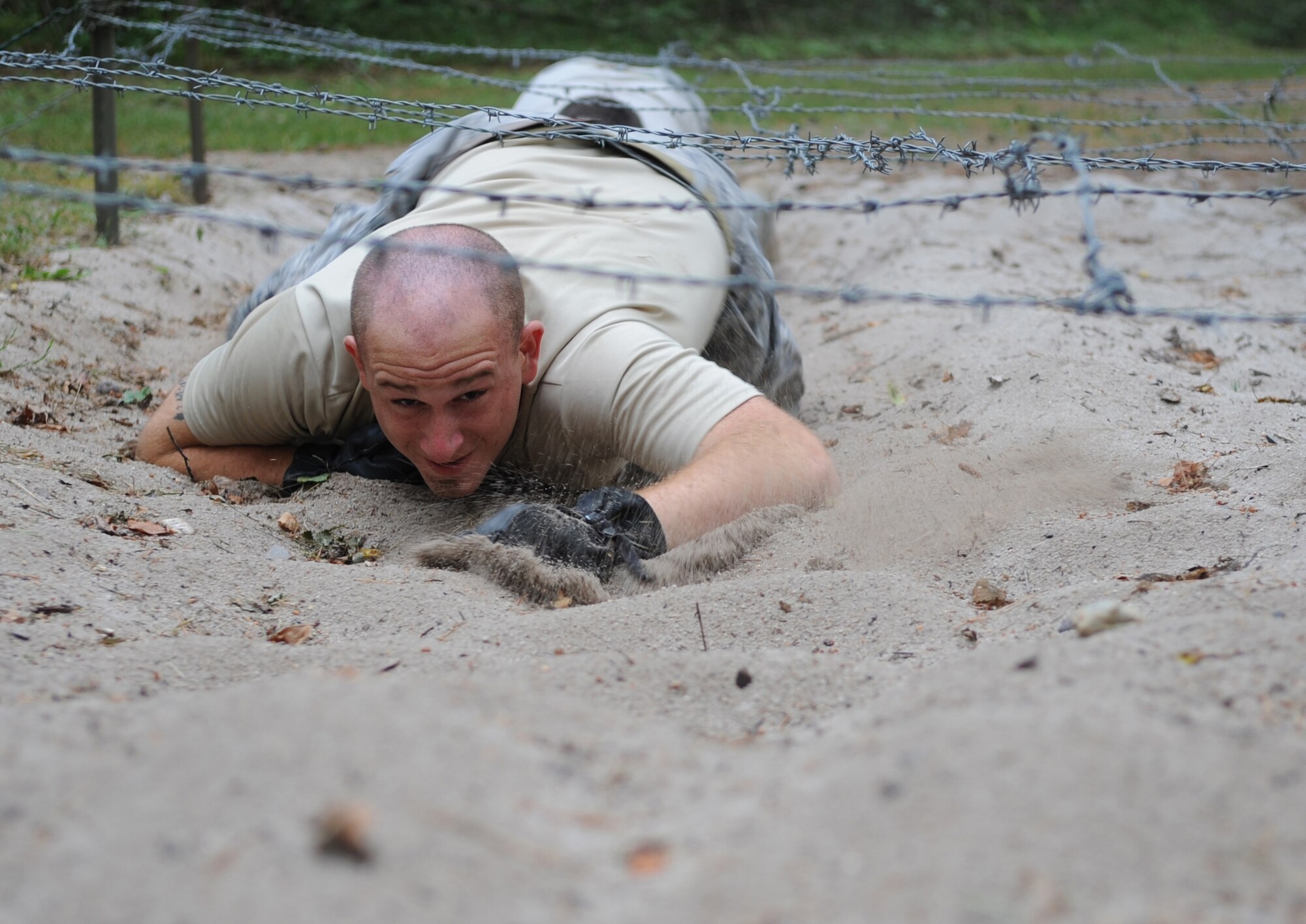 U.S. Air Force 1st Lt. Douglas Sparacio, 4th Air Support Operations Squadron intelligence duty officer stationed at  Sullivan Barracks, Mannheim, Germany, attempts to complete an obstacle during ALLIED STRIKE 10, Grafenwoehr, Germany, July 23, 2010. AS 10 is Europe's premier close air support (CAS) exercise, held annually to conduct robust, realistic CAS training that helps build partnership capacity among allied North Atlantic Treaty Organization nations and joint services while refining the latest operational CAS tactics. For more ALLIED STRIKE information go to www.usafe.af.mil/alliedstrike.asp. (U.S. Air Force photo by Senior Airman Caleb Pierce)